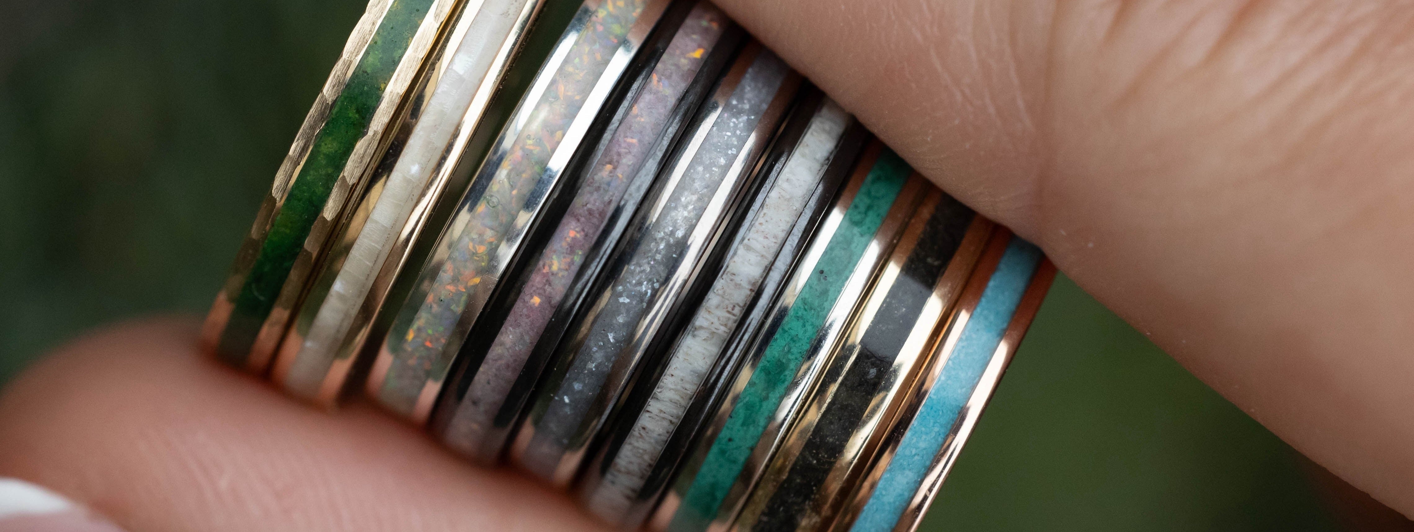 Hand holding multiple wedding bands