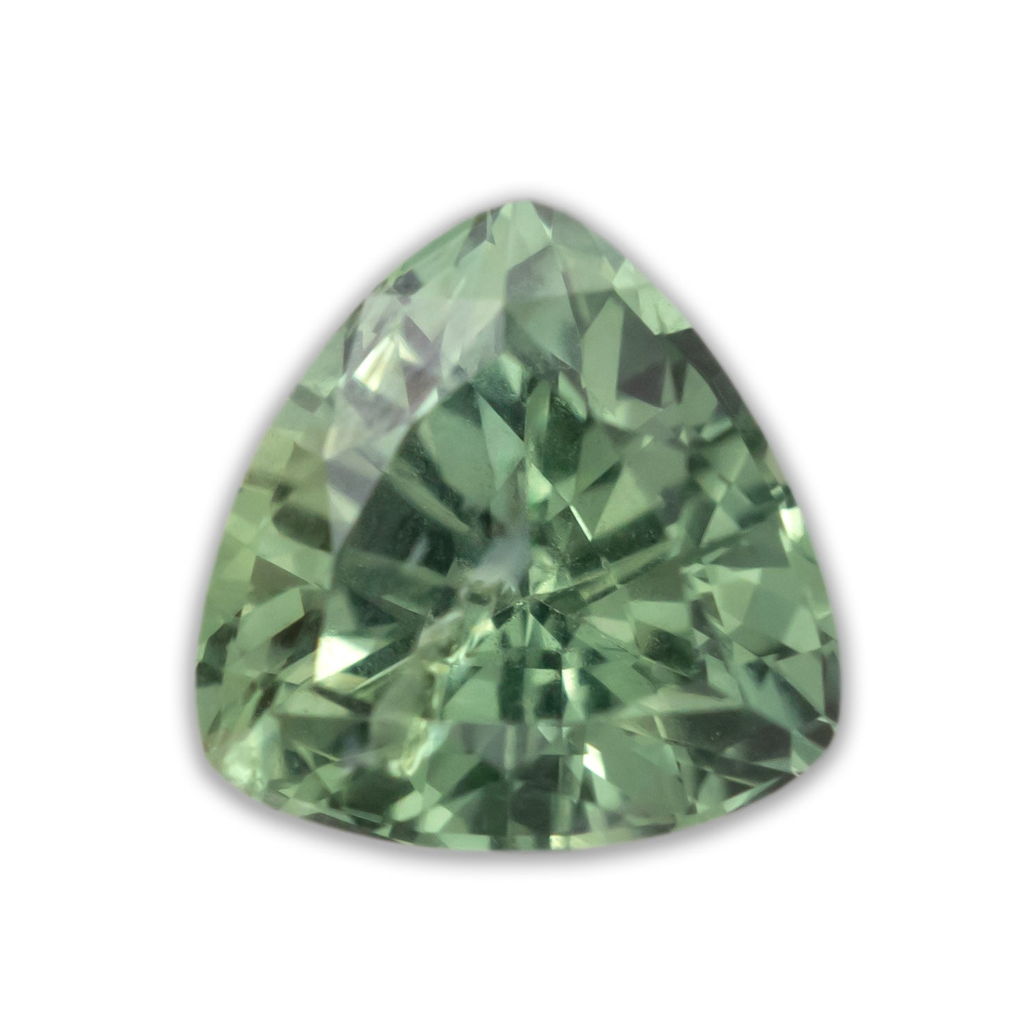A trillion cut green sapphire against a white background