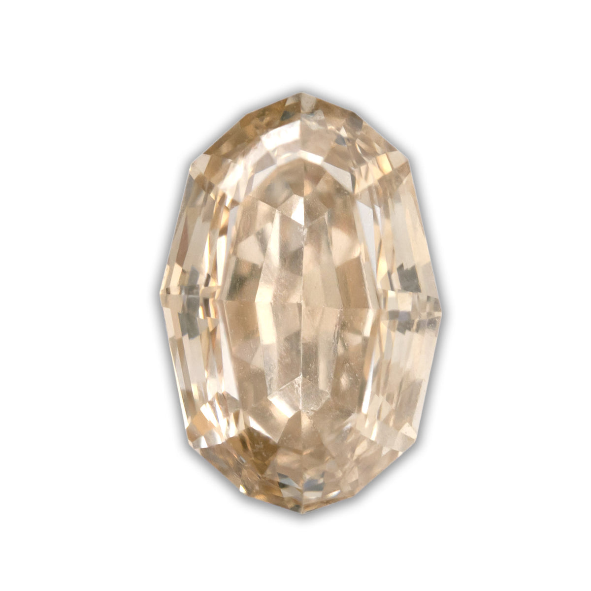 An oval cut champagne diamond on a white background