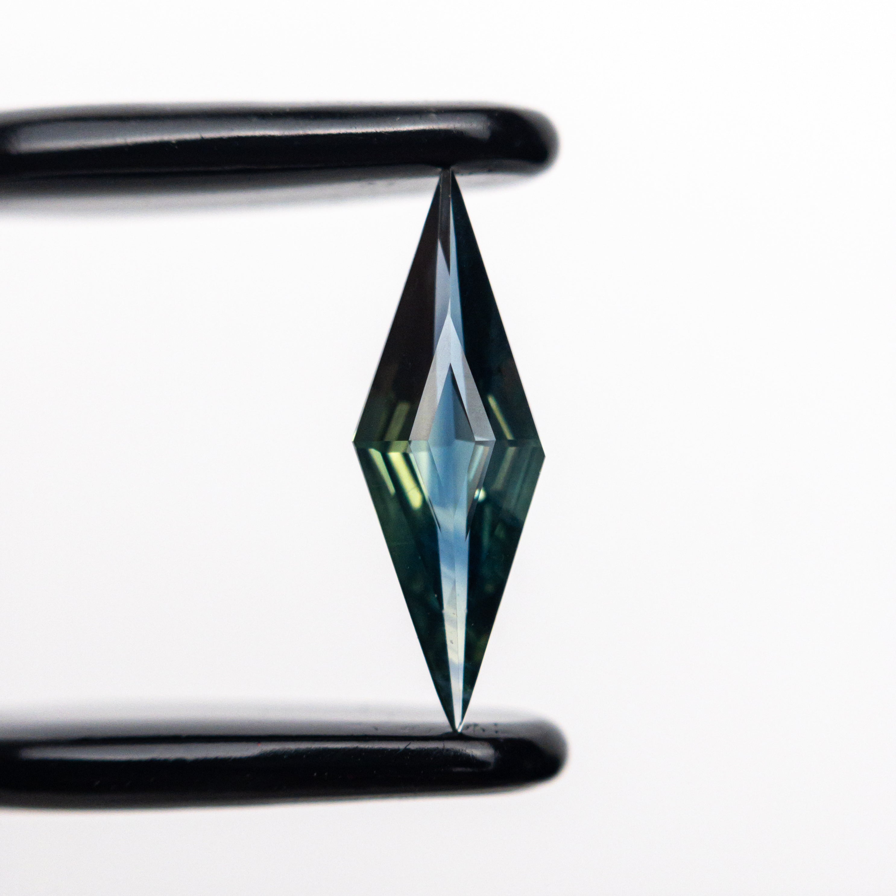 0.55ct 11.81x3.99x2.27mm Lozenge Step Cut Sapphire 25196-09-Staghead Designs