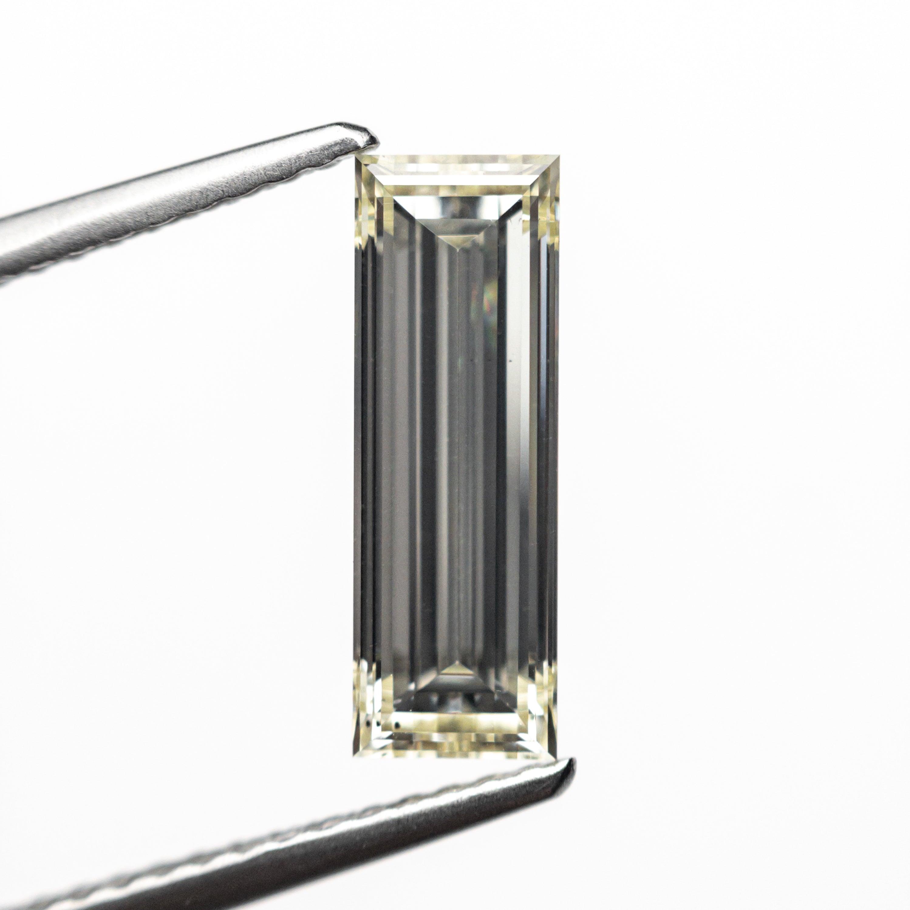 1.52ct 12.21x4.16x2.86mm VS2 O-P Baguette Step Cut 26124-01-Staghead Designs