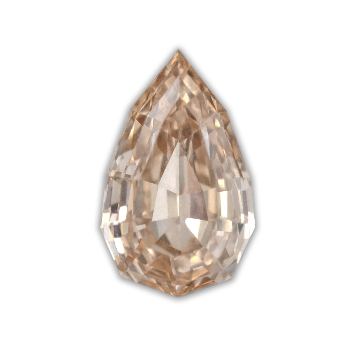 A pear cut diamond with champagne color against a white background