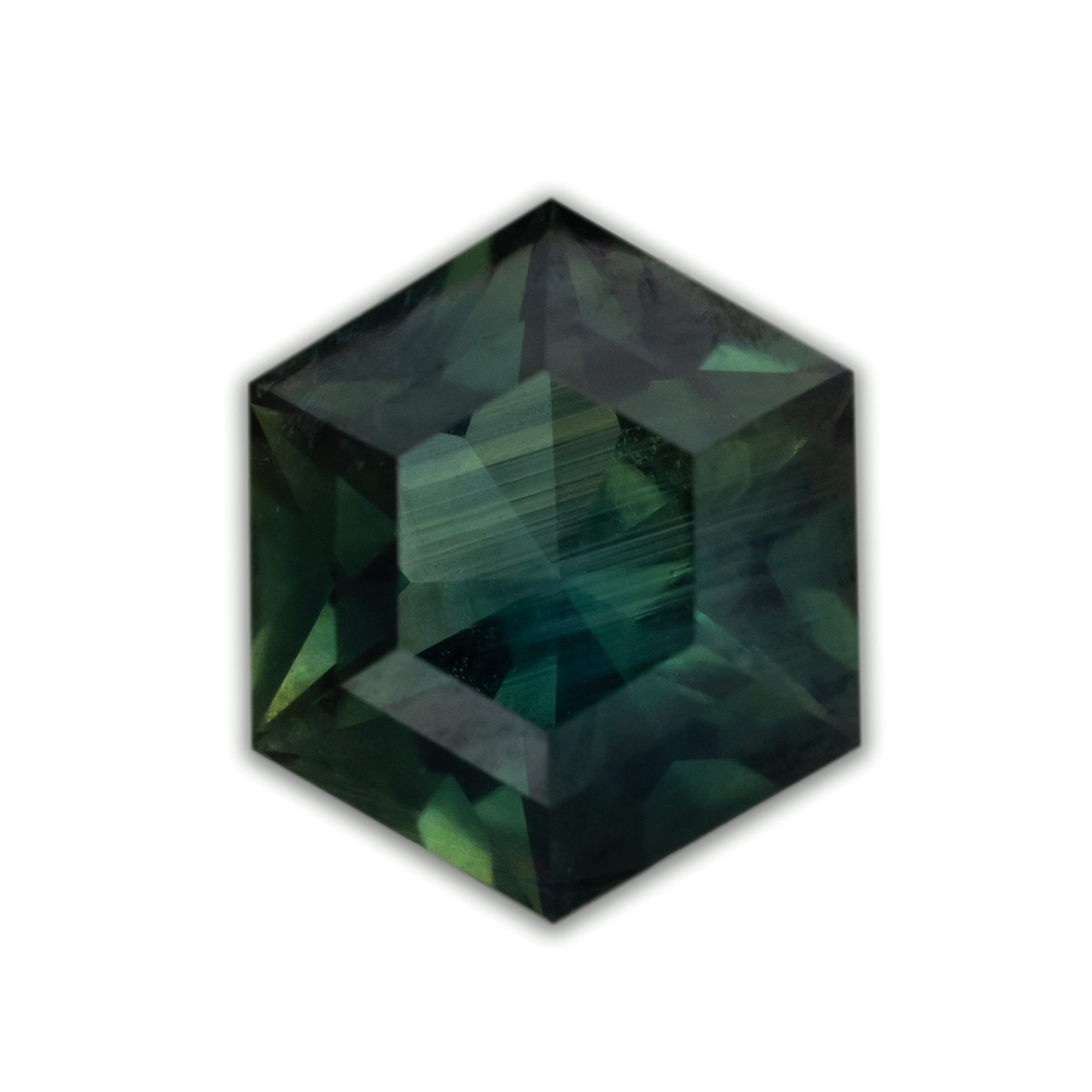 Dark green hexagon cut sapphire with inclusions on a white background