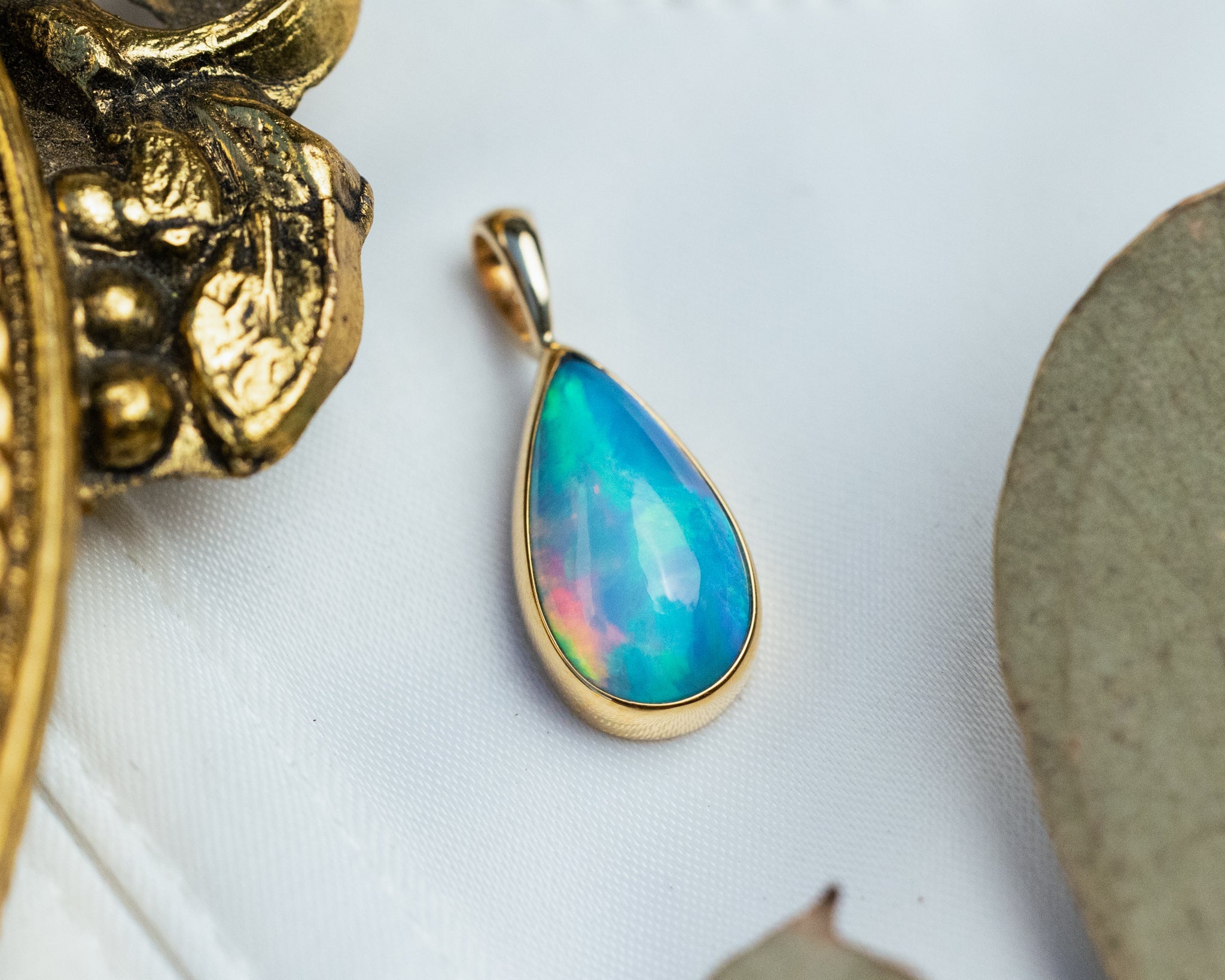 BEZEL SET ETHIOPIAN OPAL PENDANT IN 14K YELLOW GOLD