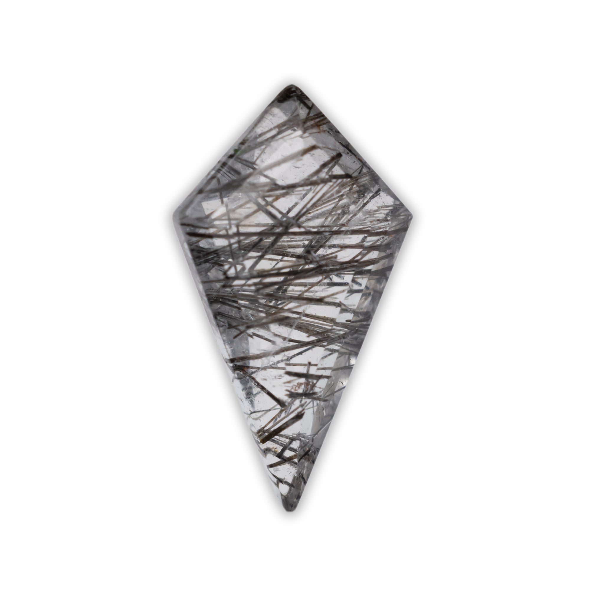 Clear quartz with black needle like inclusions throughout the stone on a white background