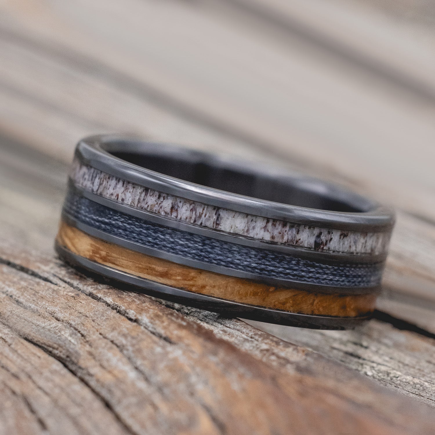 "Rio" - men's wedding ring featuring 3 channels with antler, grey fishing line & whiskey barrel oak inlays