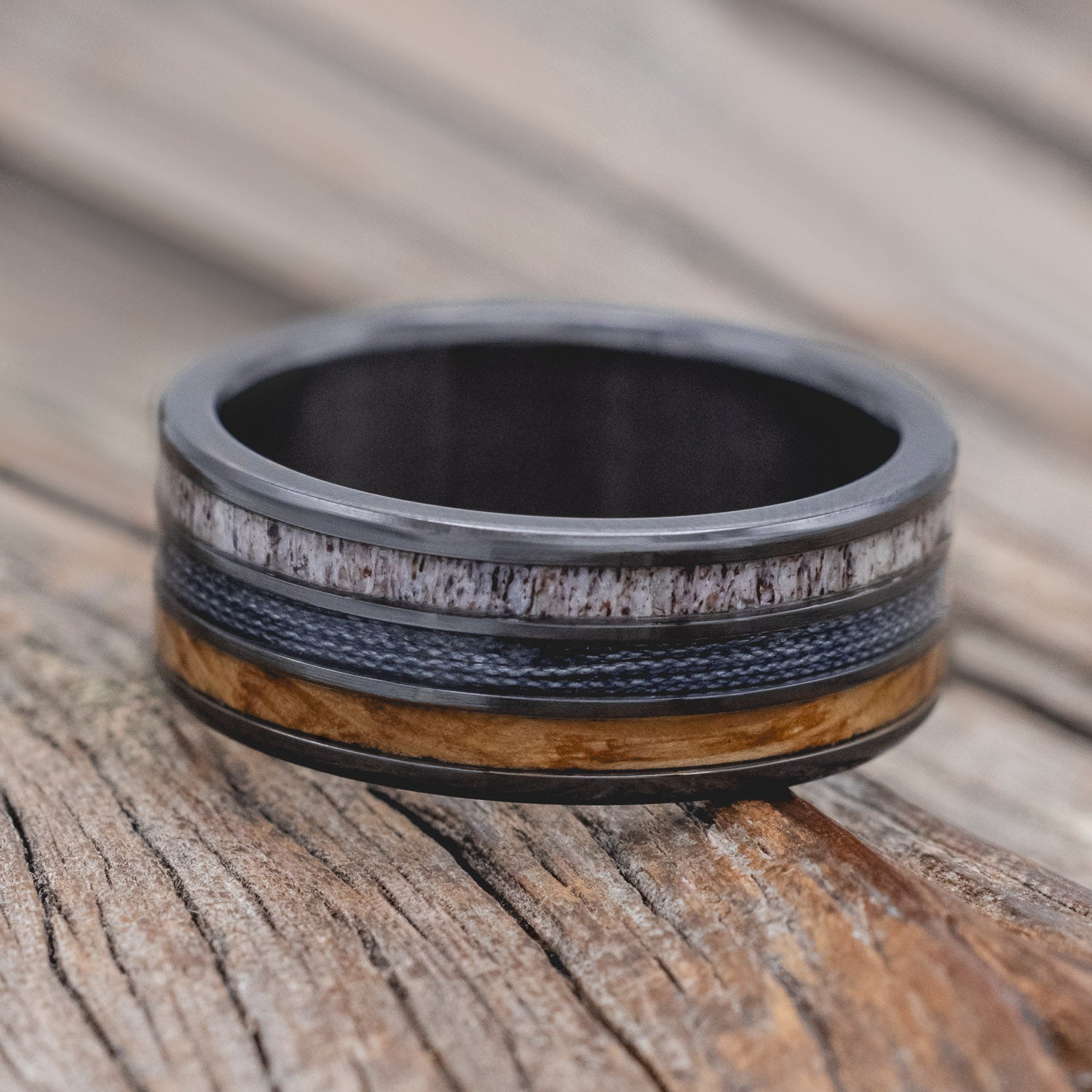 "Rio" - men's wedding ring featuring 3 channels with antler, grey fishing line & whiskey barrel oak inlays