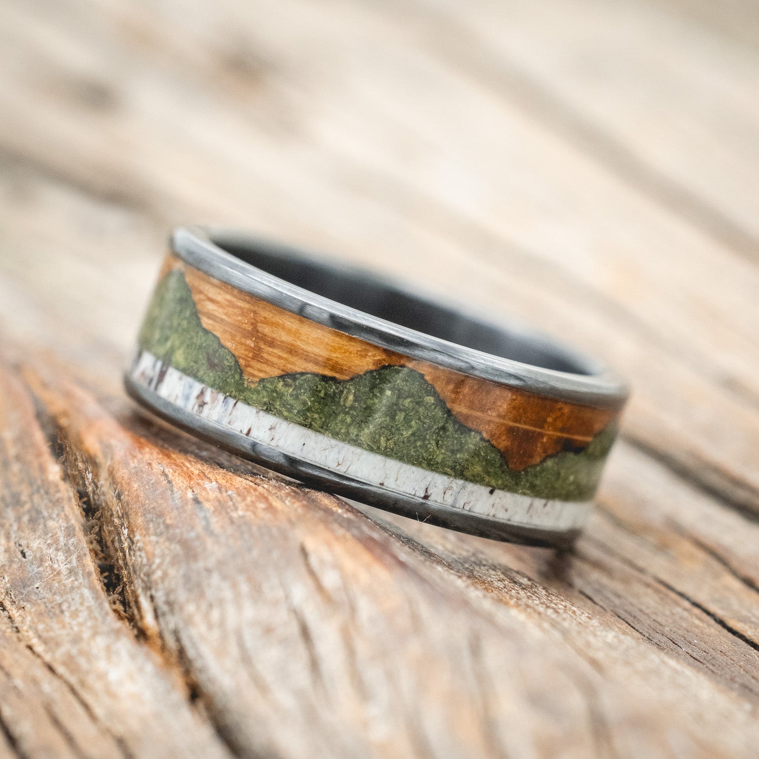 "Voyager" - men's wedding ring featuring moss-filled mountain engraving with whiskey barrel oak & antler inlays