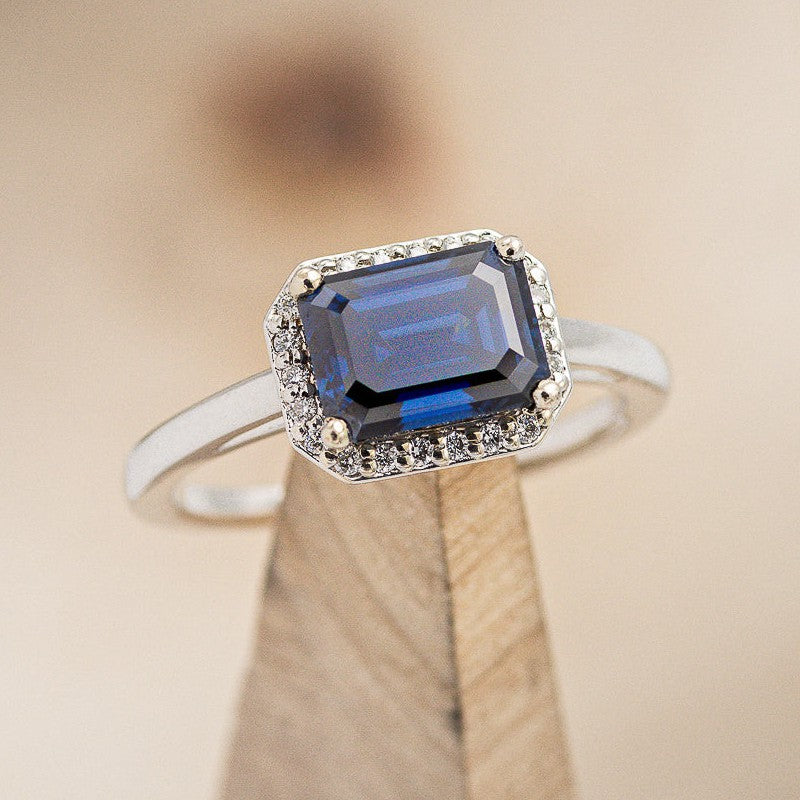 "CYBELE" - EMERALD CUT ACTAEON BLUE MOISSANITE ENGAGEMENT RING WITH DIAMOND HALO-1