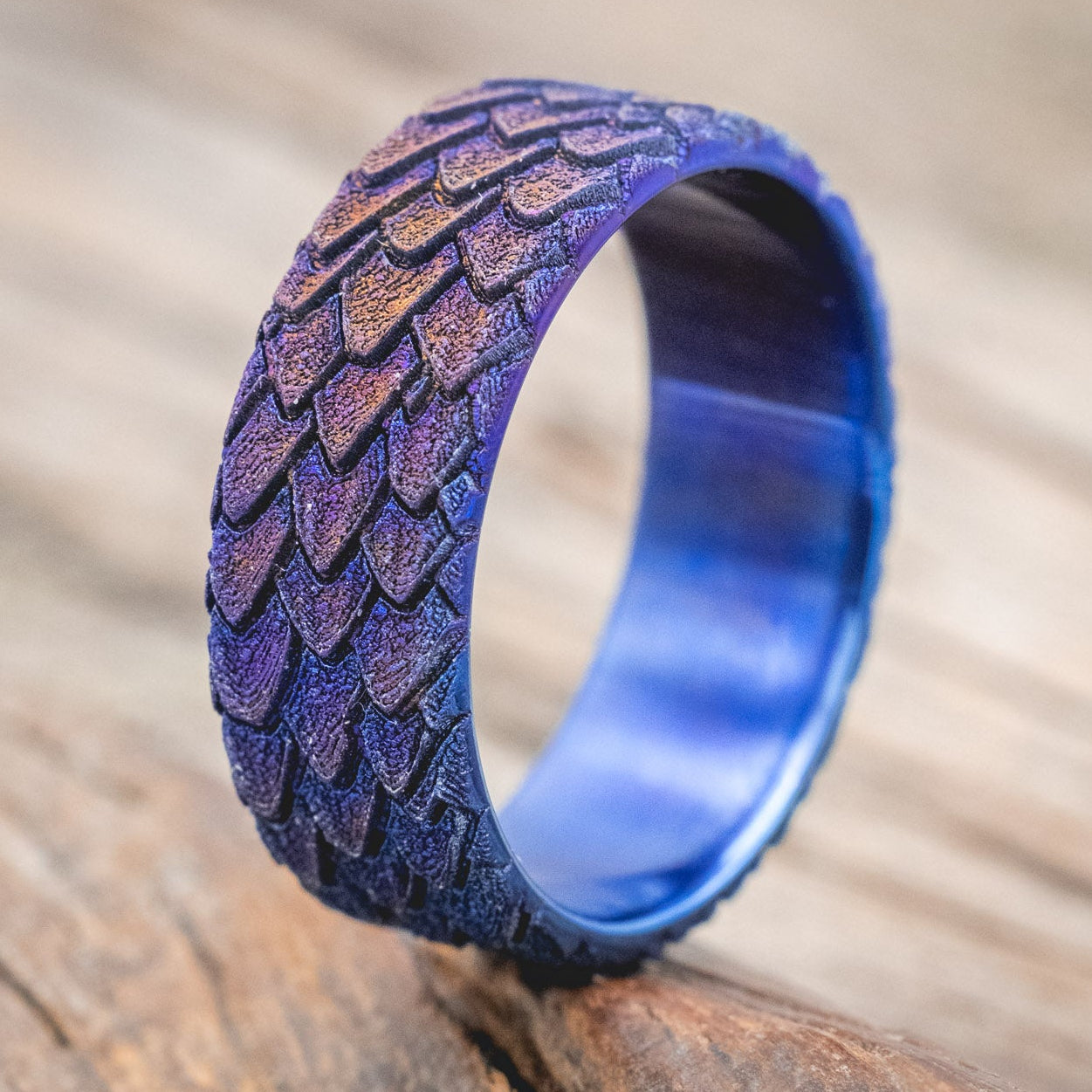 "Echo" thicker wedding band featuring fire-treated titanium with a custom embossed 3D dragon scale