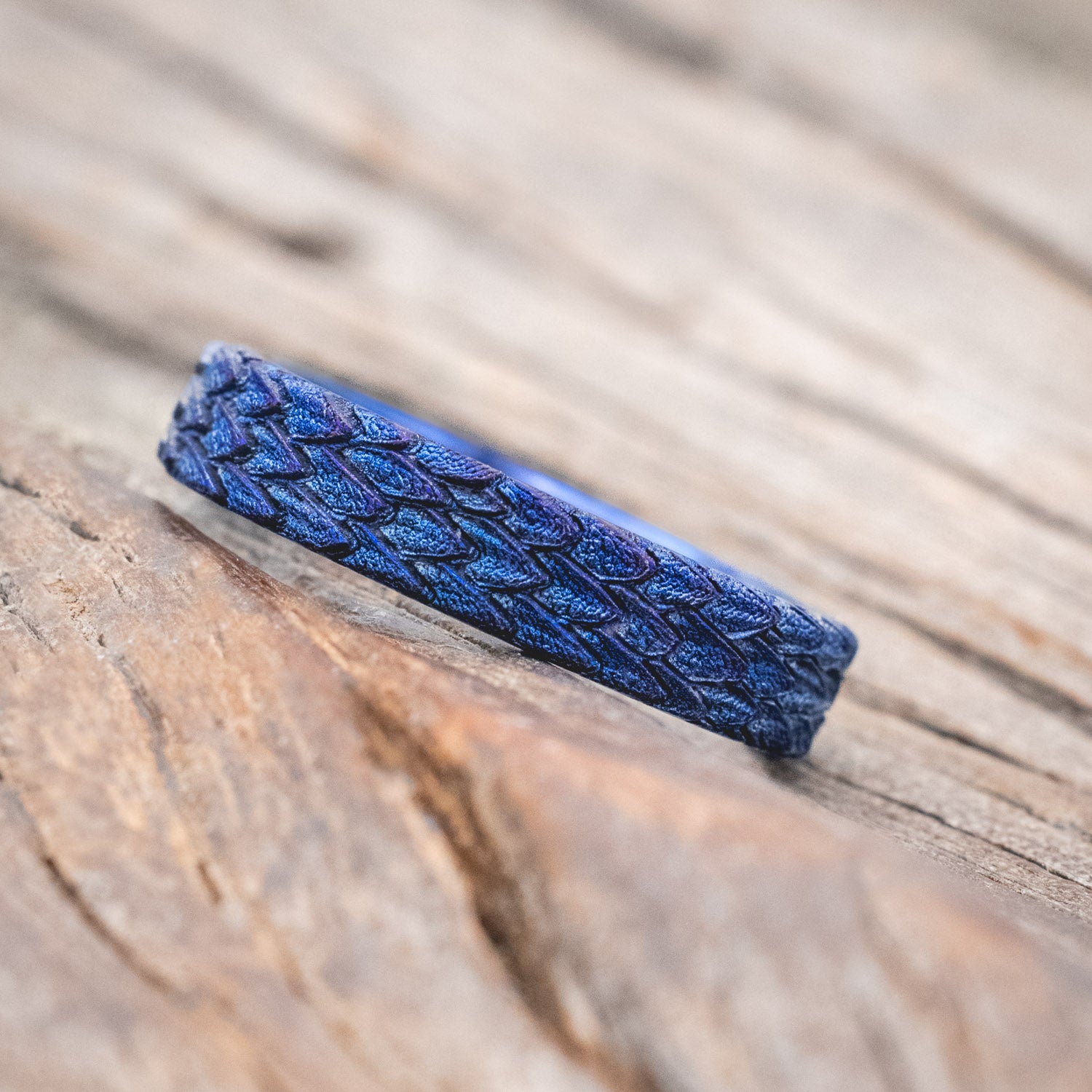 "Echo" thinner wedding band featuring fire-treated titanium with a custom embossed 3D dragon scale