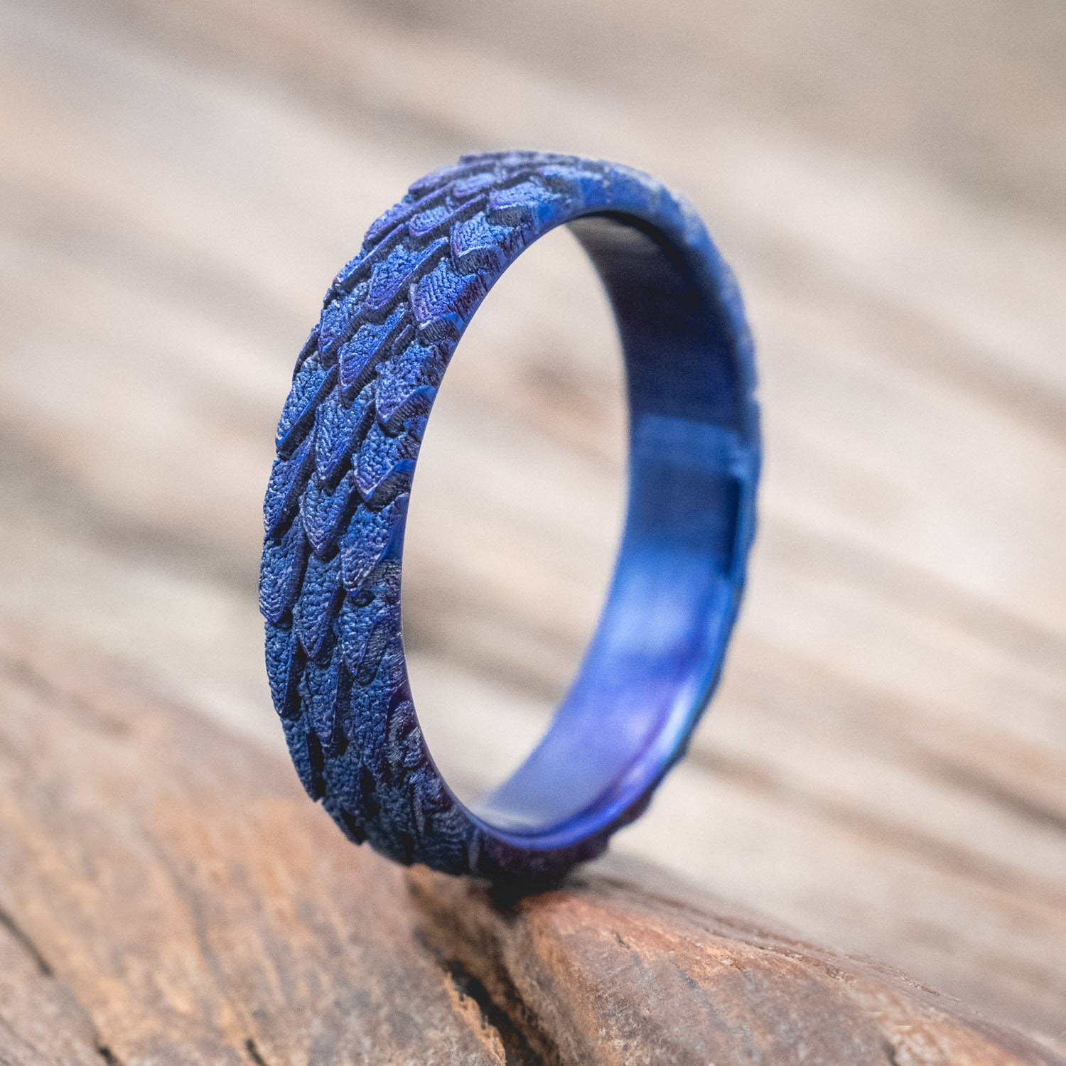 "Echo" thinner wedding band featuring fire-treated titanium with a custom embossed 3D dragon scale