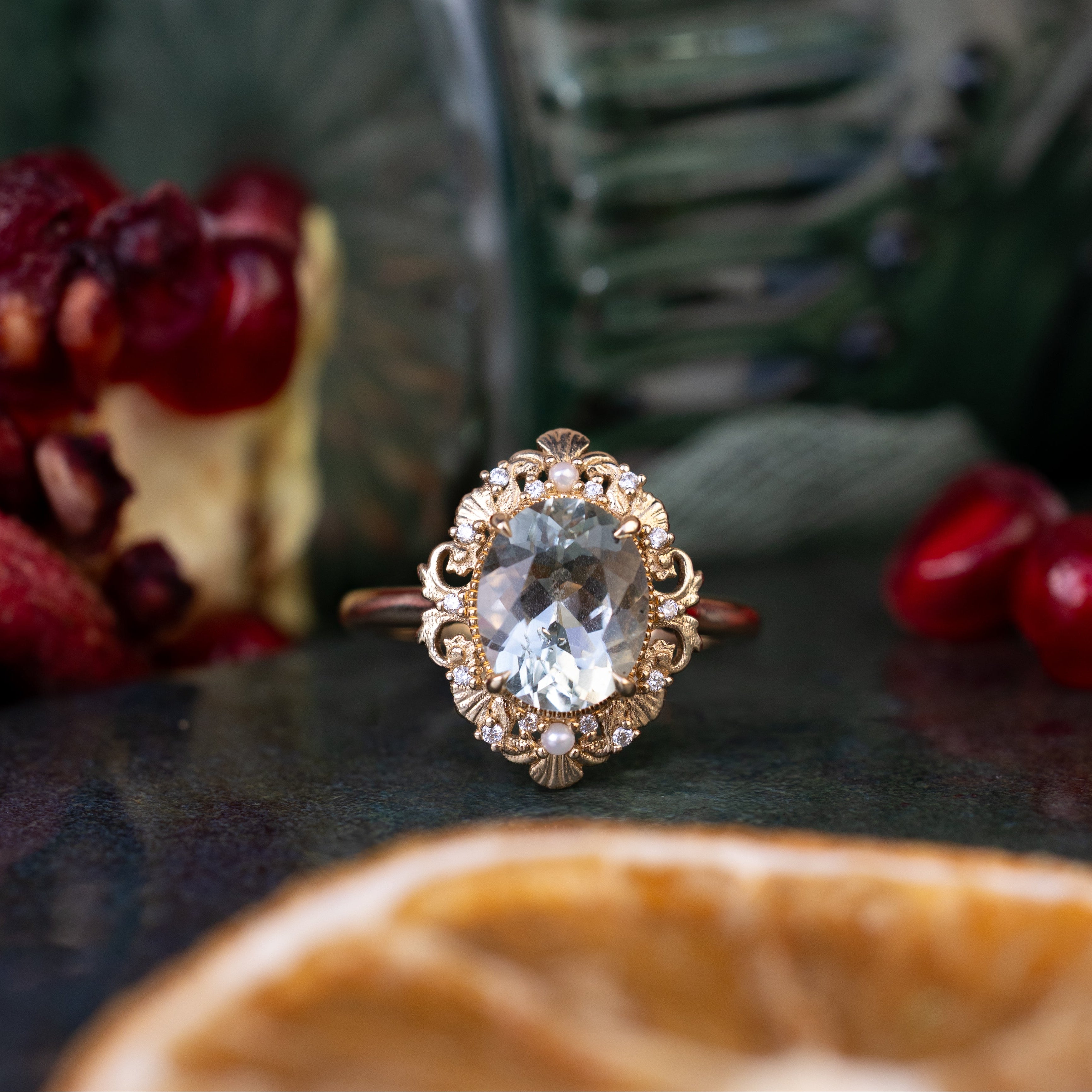 Gold ring with a large gemstone on a dark surface with blurred background