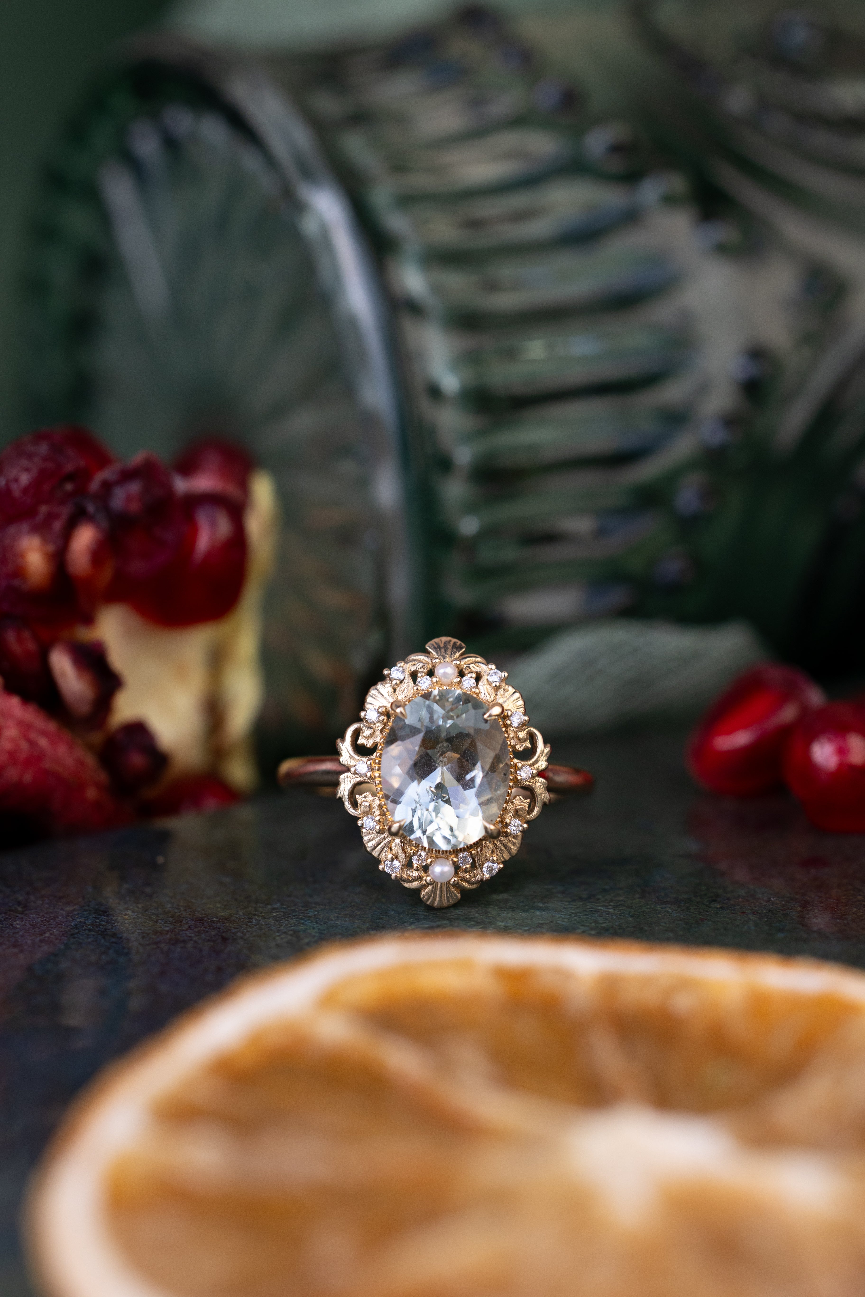 Gold ring with a large gemstone on a dark surface with blurred background
