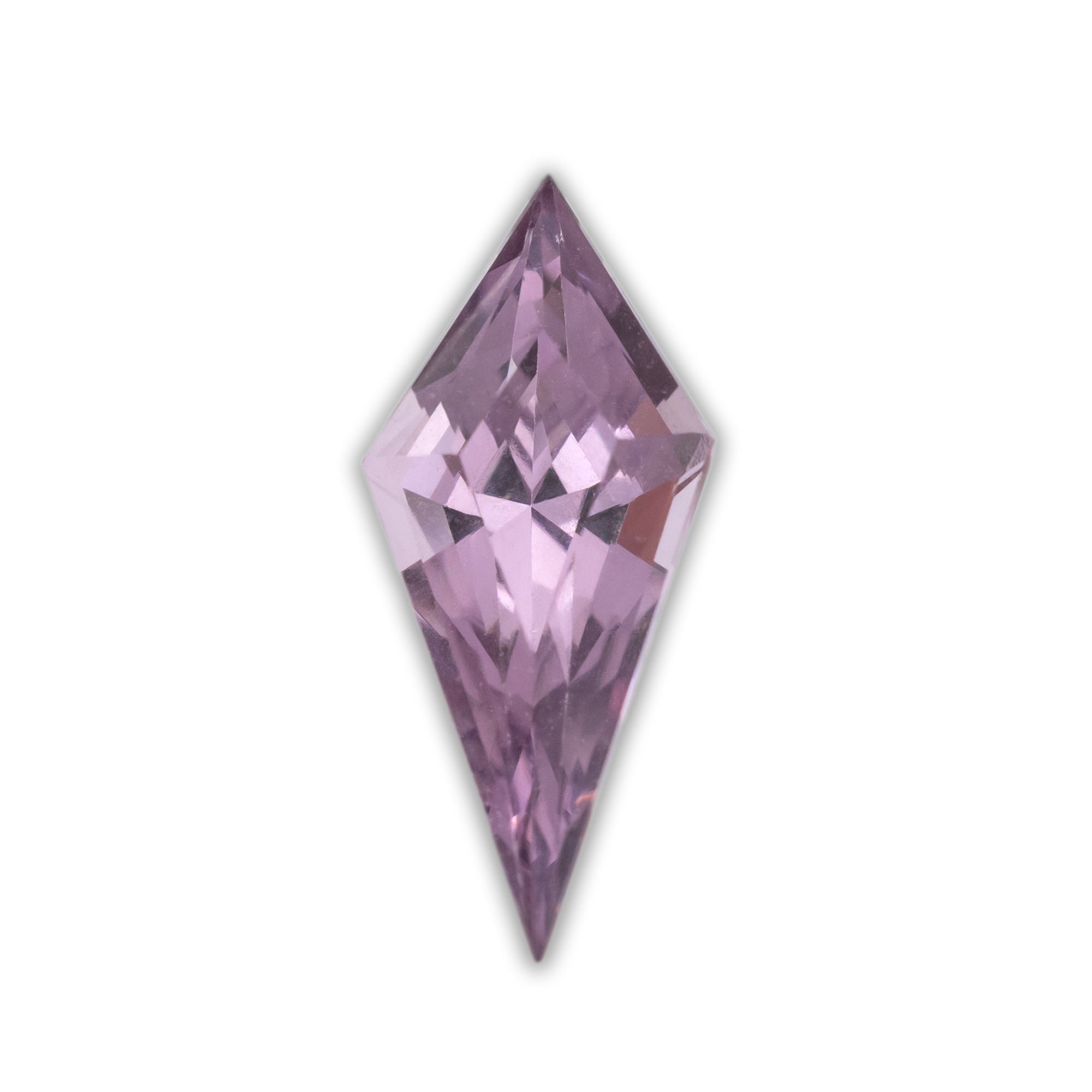 Kite cut spinel with a purplish pink color on a white background