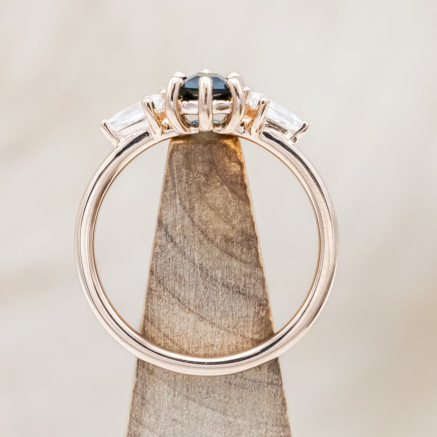 Side view of "Isla" - elongated hexagon cut Australian sapphire with moissanite accents in 14K rose gold