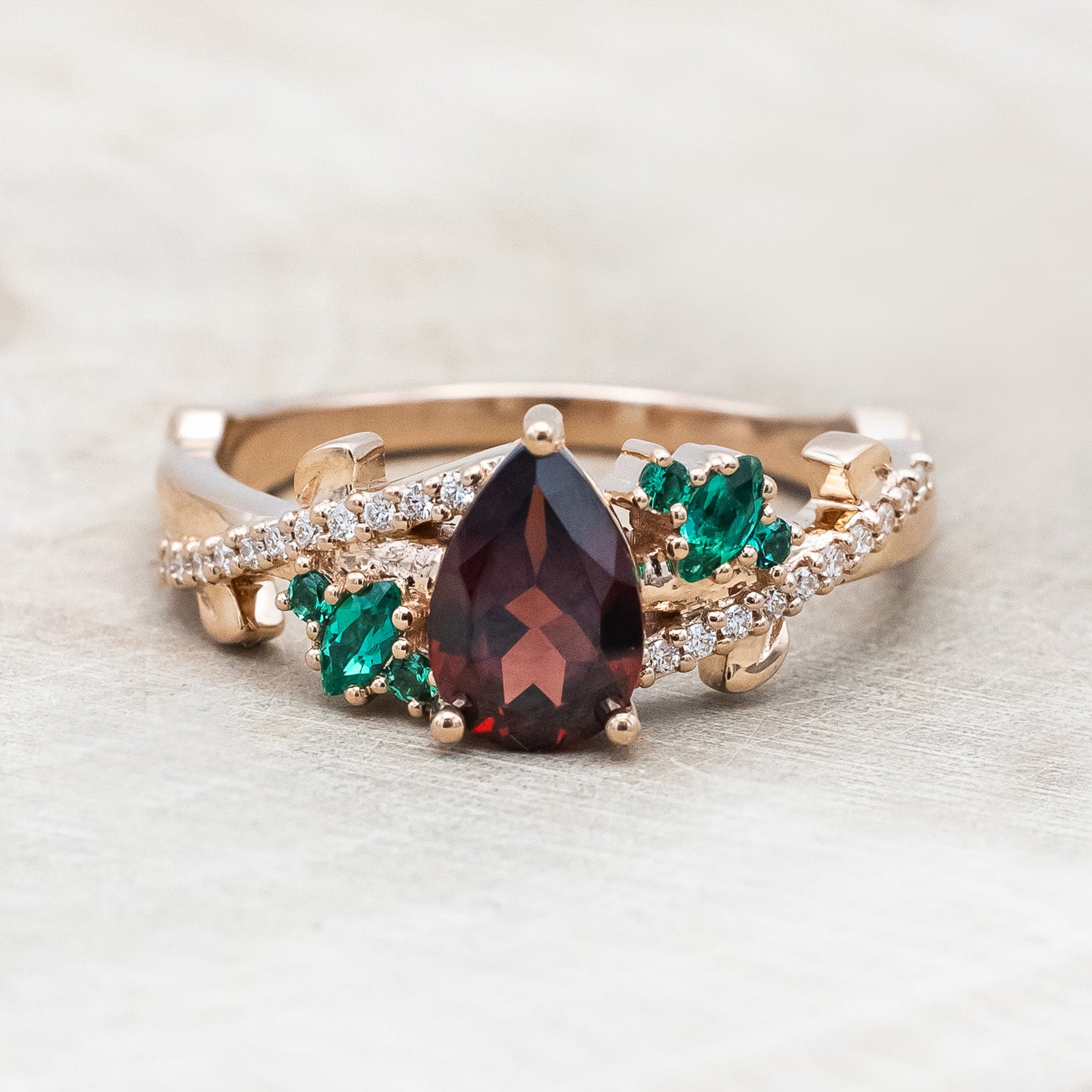 "KAMILA" - PEAR CUT MOZAMBIQUE GARNET ENGAGEMENT RING WITH EMERALD & DIAMOND ACCENTS-Staghead Designs