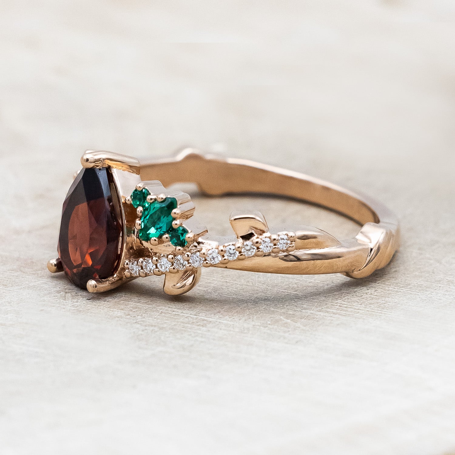 "KAMILA" - PEAR CUT MOZAMBIQUE GARNET ENGAGEMENT RING WITH EMERALD & DIAMOND ACCENTS-Staghead Designs