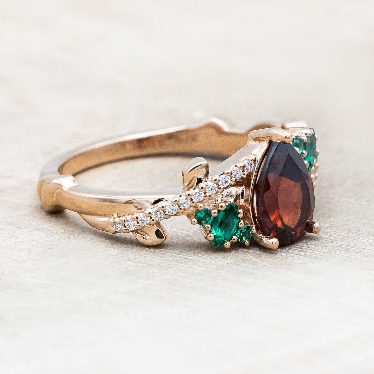 "KAMILA" - PEAR CUT MOZAMBIQUE GARNET ENGAGEMENT RING WITH EMERALD & DIAMOND ACCENTS-Staghead Designs
