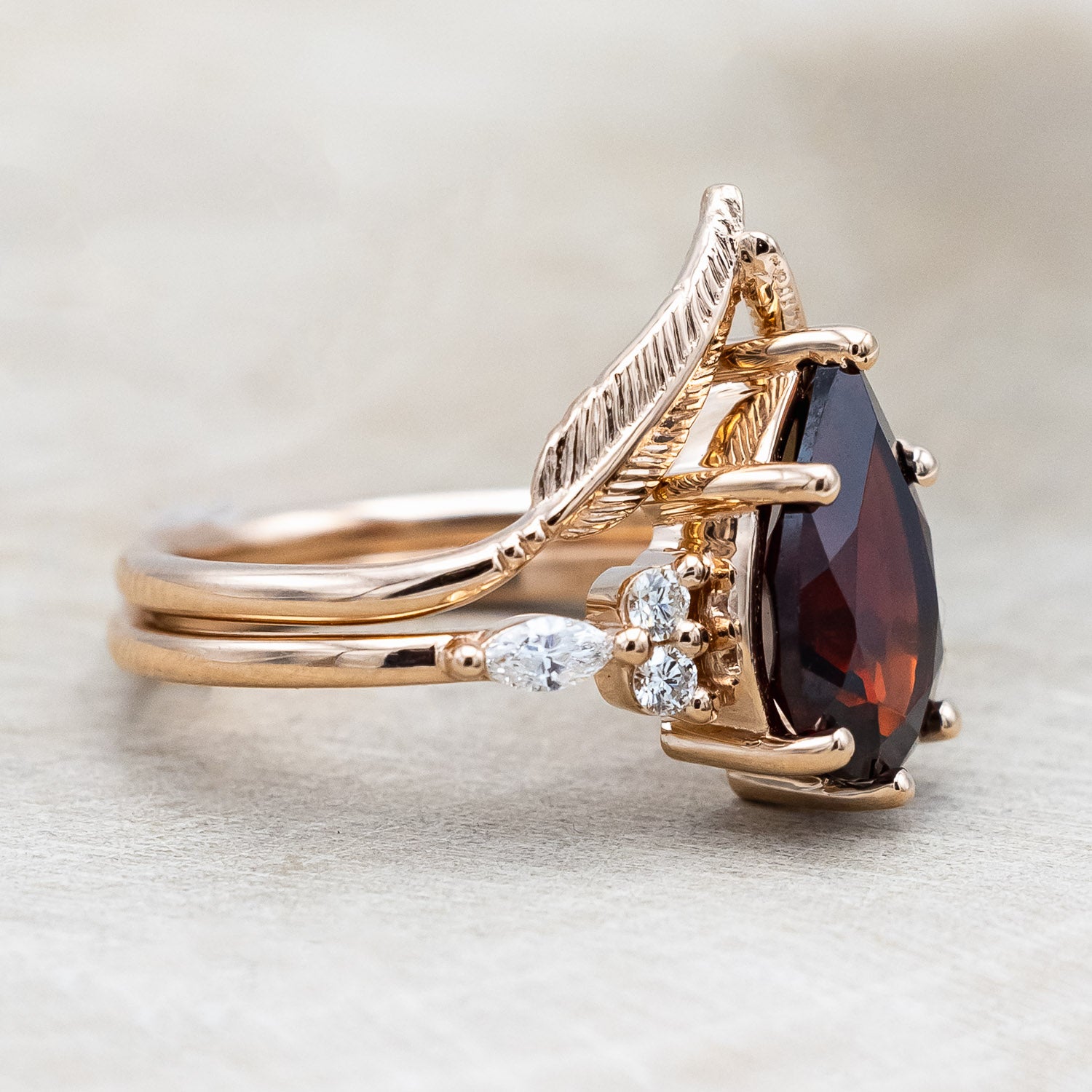 Side view of "Sage" - garnet women's engagement ring with diamond accents & "Fala" feather-style tracer