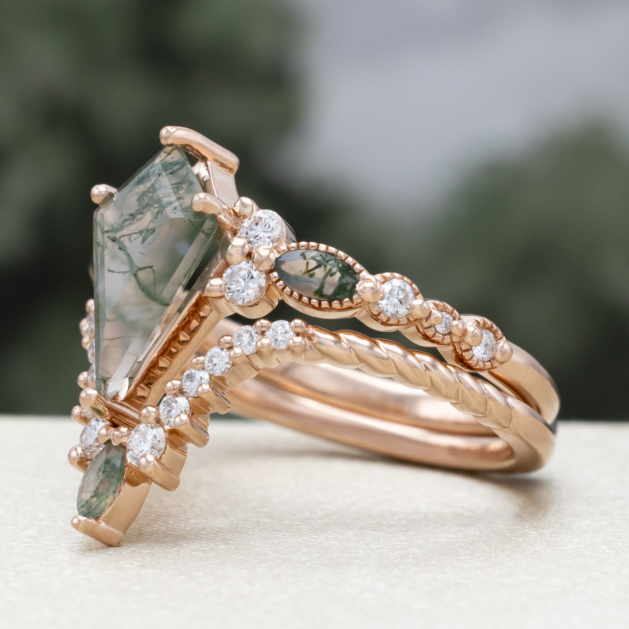"Shimmering Sage" - Bridal Suite - Kite Cut Moss Agate Engagement Ring With Marquise Moss Agate Accents & A Diamond Tracer-Staghead Designs