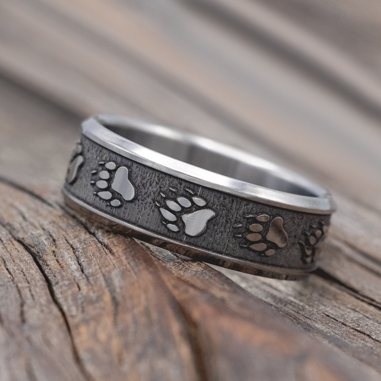 "Legacy" - embossed wedding rings with bear paw engravings on channel-style band.