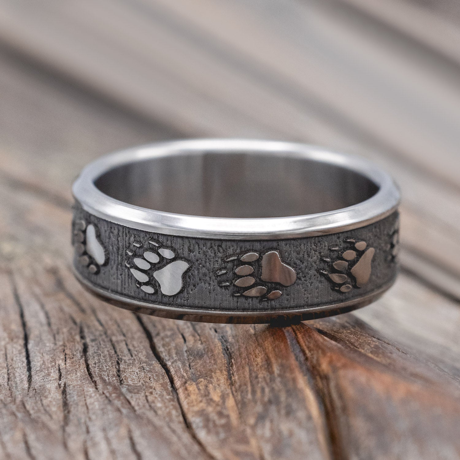 "Legacy" - embossed wedding rings with bear paw engravings on channel-style band.