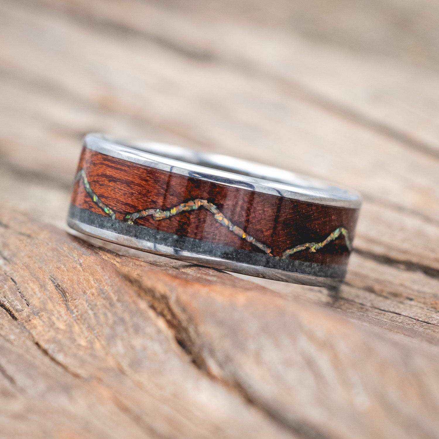 "The Expedition" - men's wedding ring featuring a mountain engraving with fire & ice opal, rosewood, and moss agate inlays