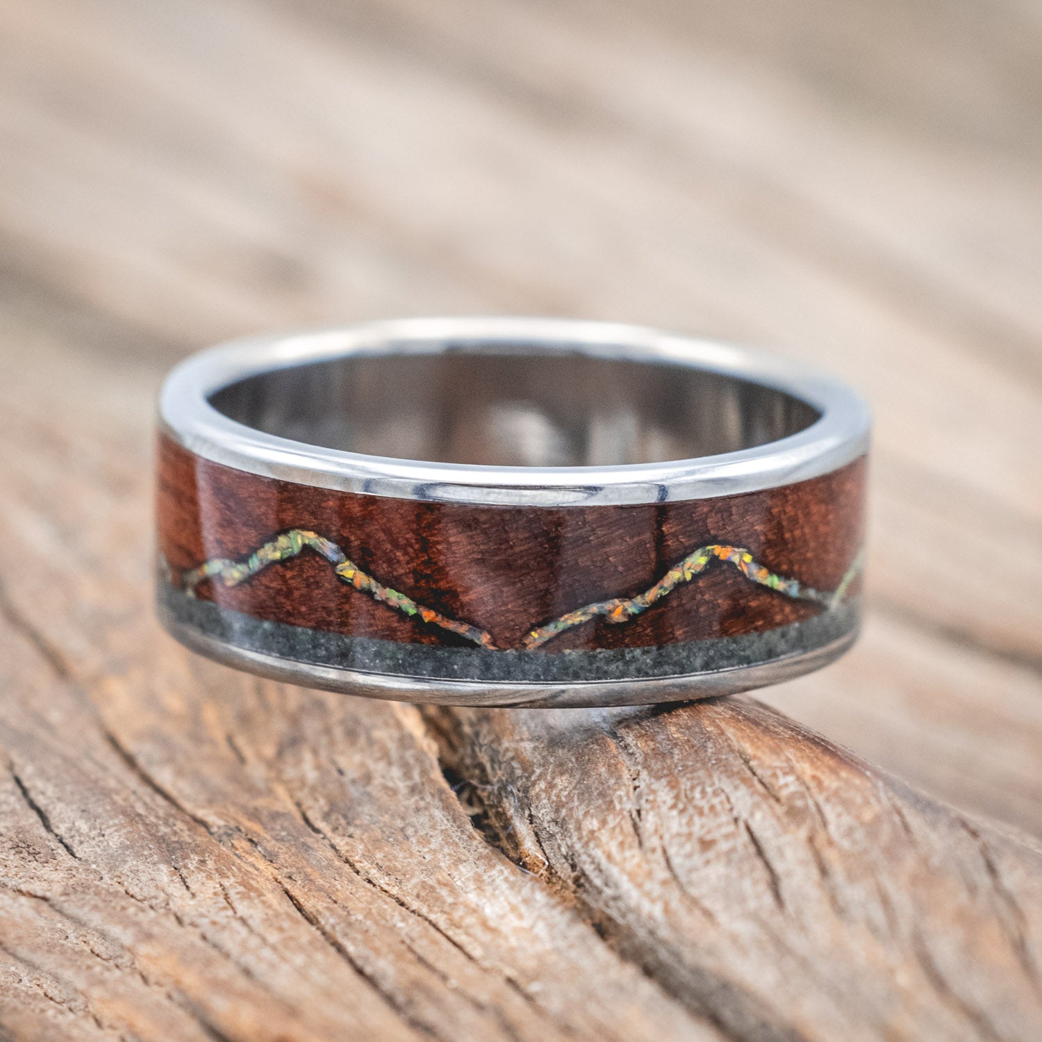 "The Expedition" - men's wedding ring featuring a mountain engraving with fire & ice opal, rosewood, and moss agate inlays