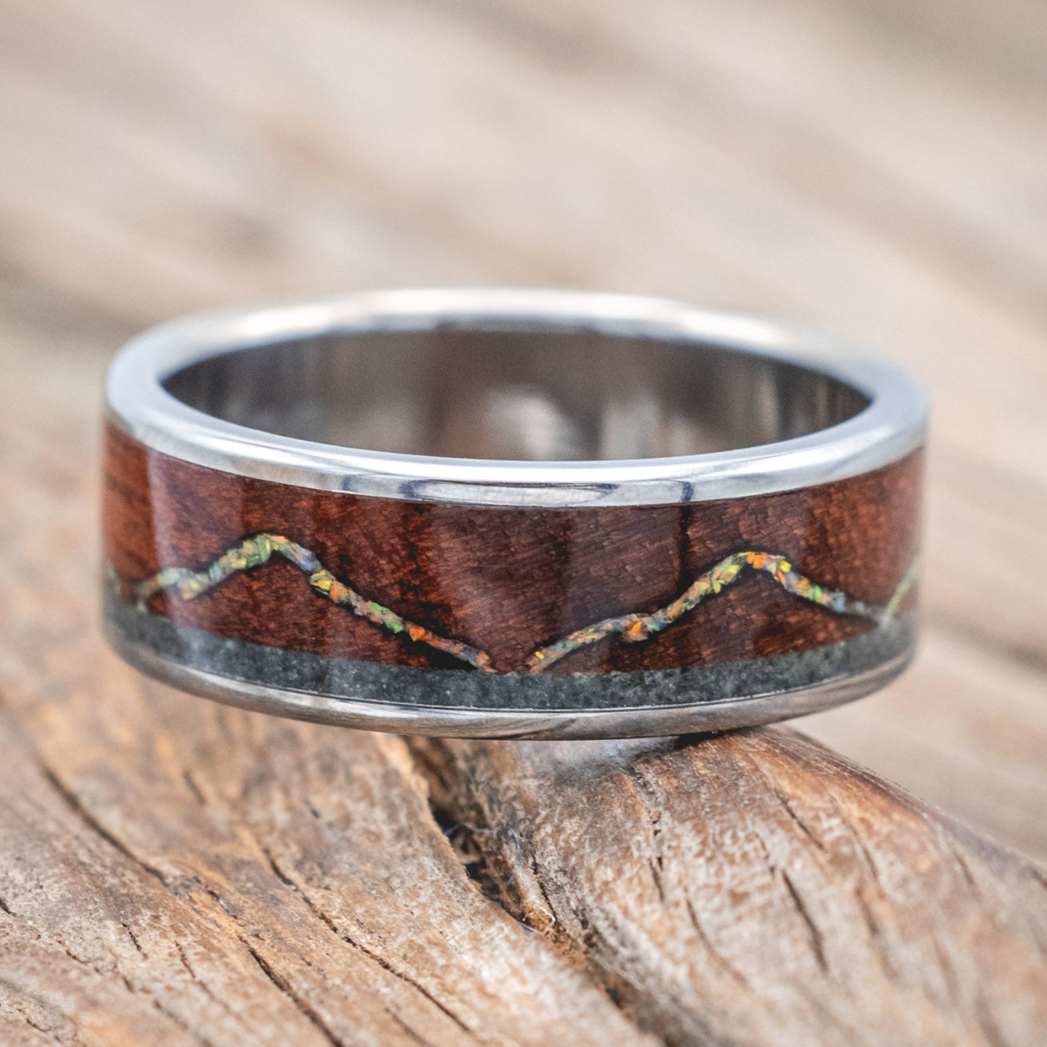 "The Expedition" - men's wedding ring featuring a mountain engraving with fire & ice opal, rosewood, and moss agate inlays