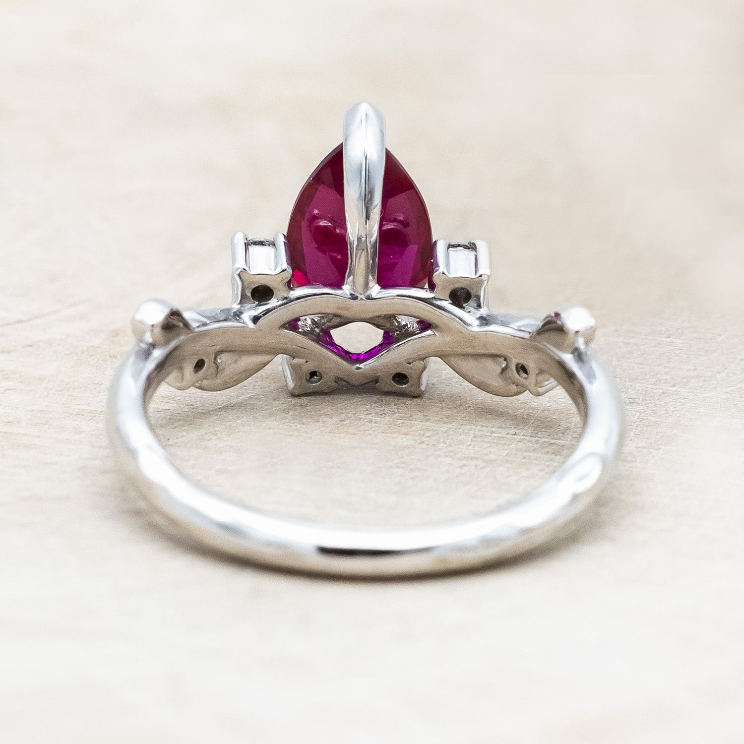 "Harlow" pear cut ruby engagement ring with salt & pepper diamond accents on a branch-inspired band