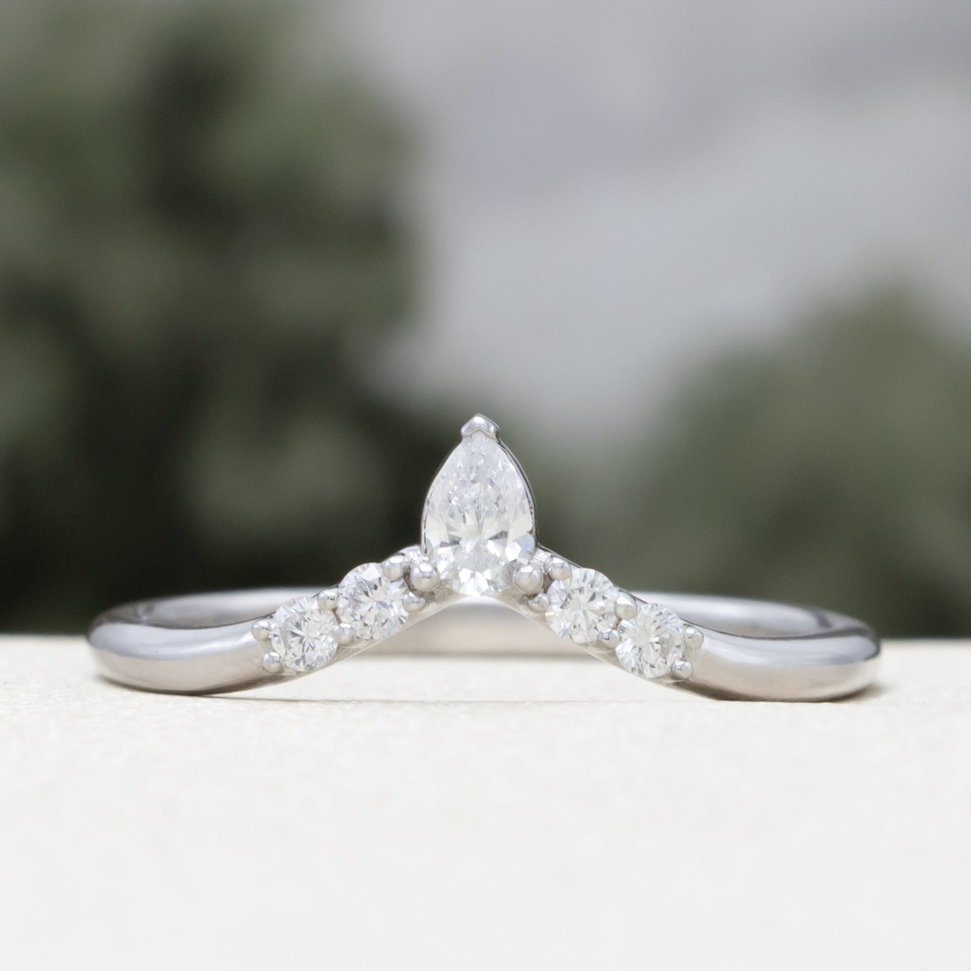 White gold tracer with diamond accents on a blurred background