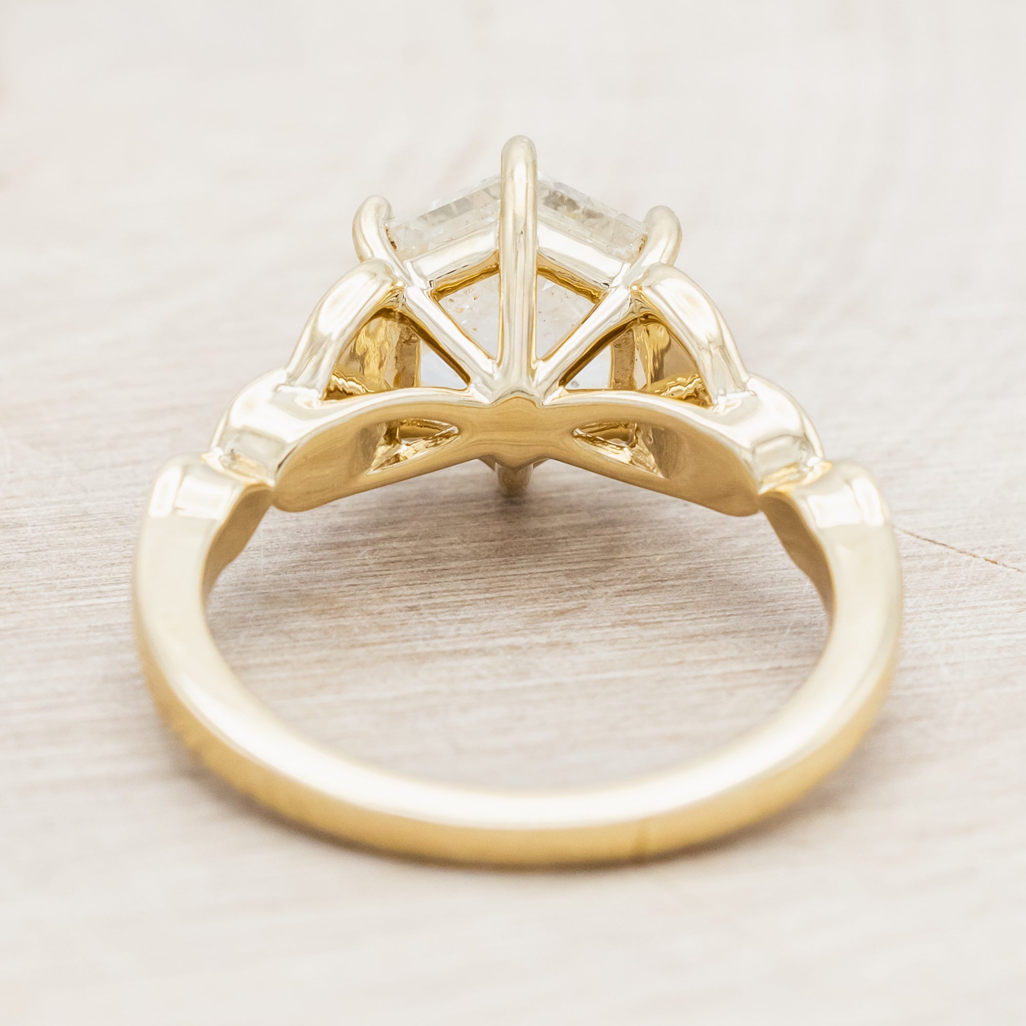 14K gold ring with an icy salt & pepper diamond on a beige background