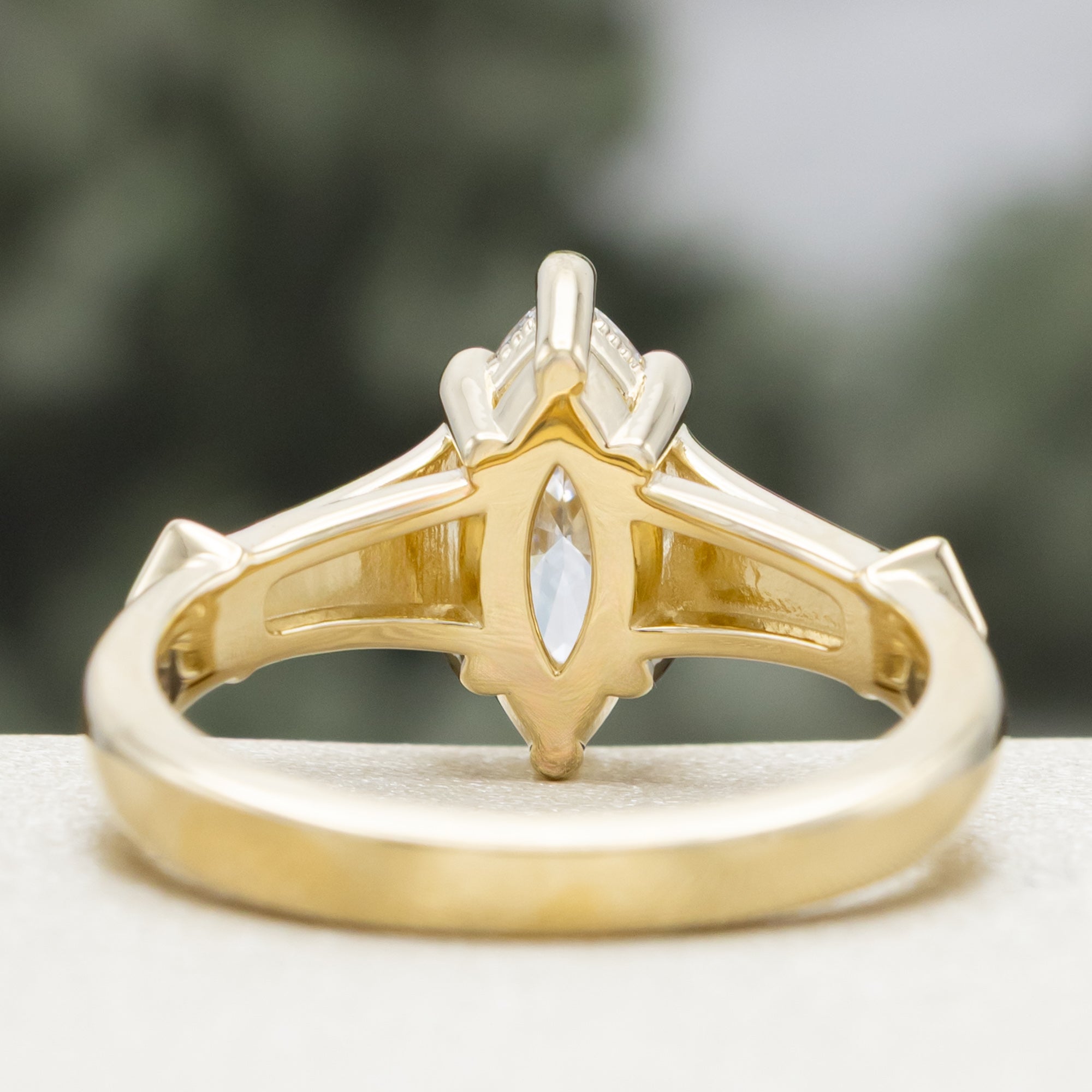 Gold lab diamond ring with diamond accents on a blurred background