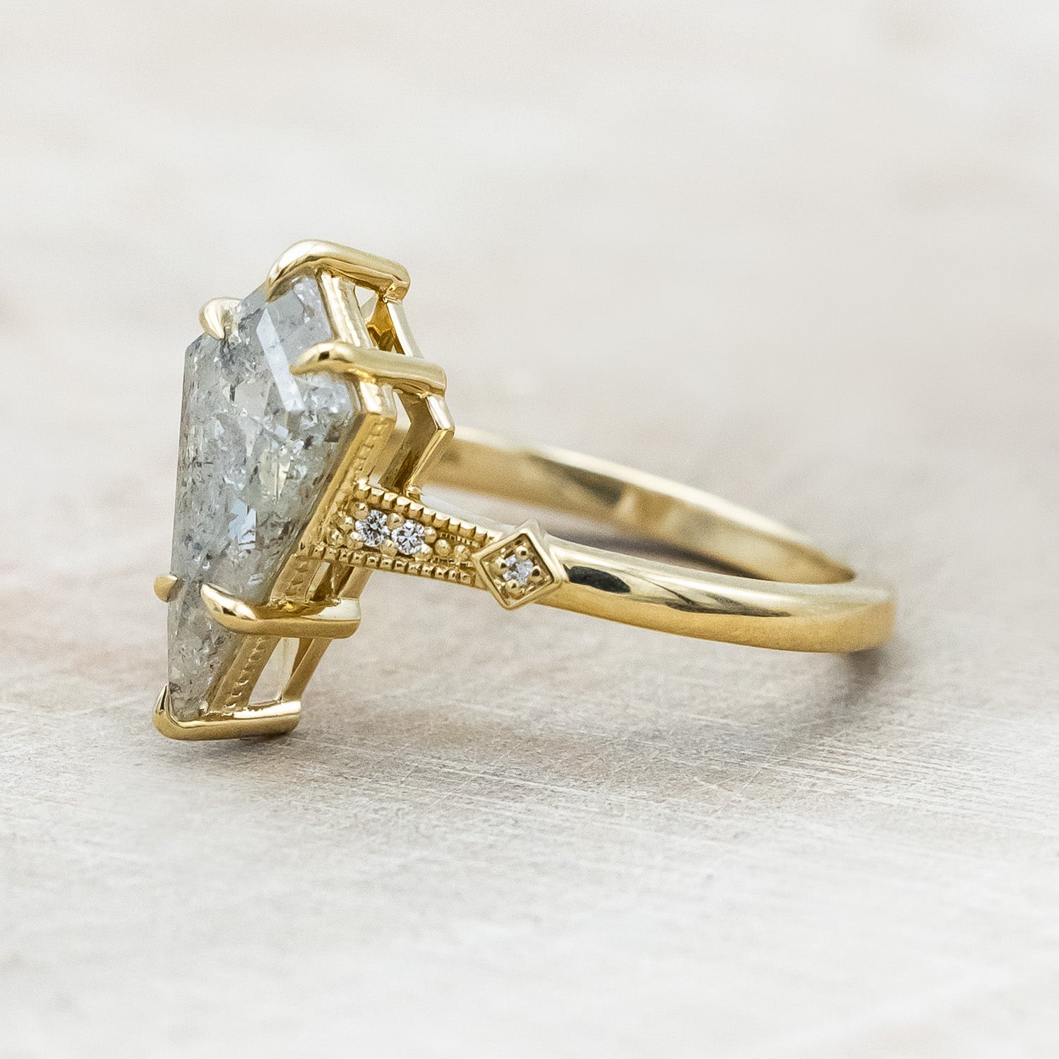 Side view of "Annora" - vintage-style women's engagement ring with kite step cut salt & pepper diamond & diamond accents in 14K yellow gold