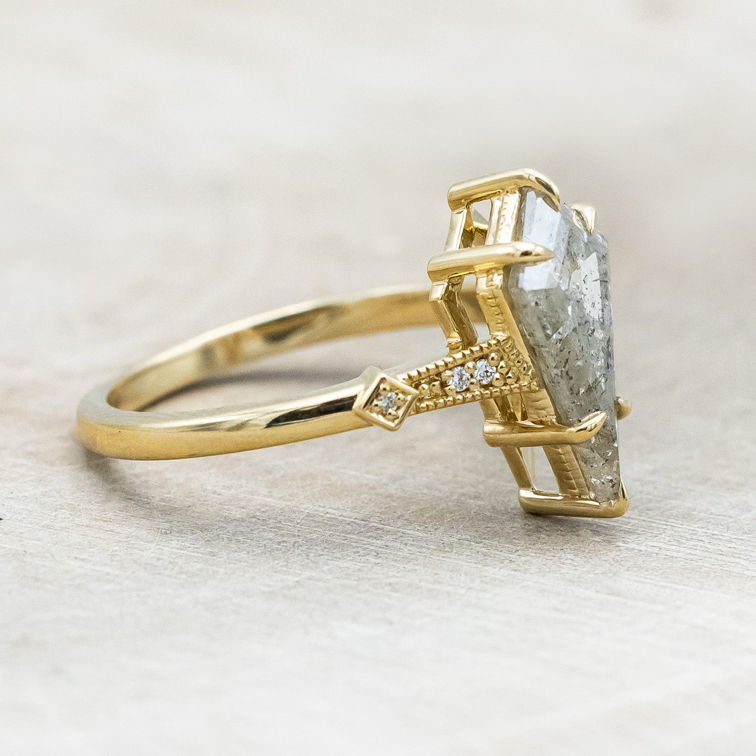 Side view of "Annora" - vintage-style women's engagement ring with kite step cut salt & pepper diamond & diamond accents in 14K yellow gold