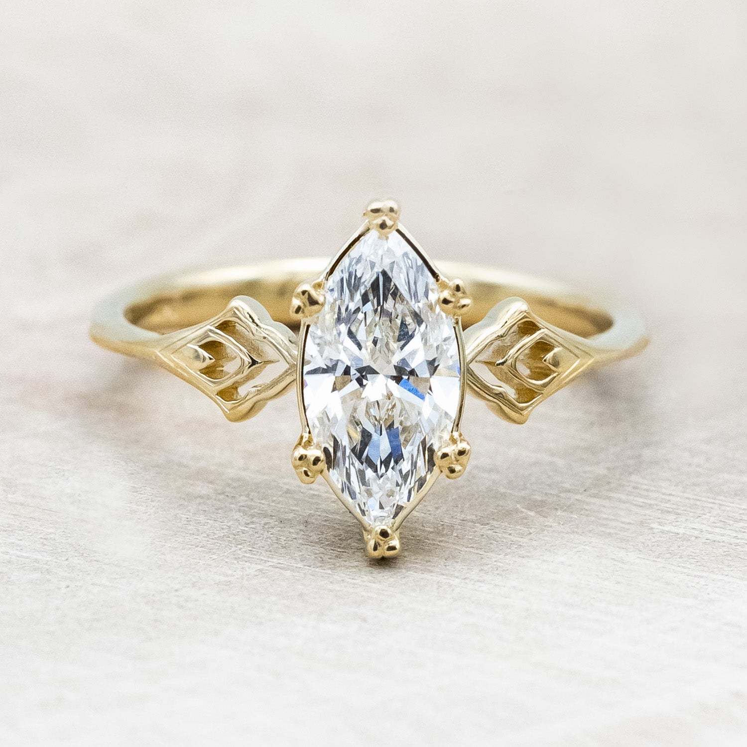 Front angle of "Morrigan" - ornate solitaire engagement ring with white marquise diamond