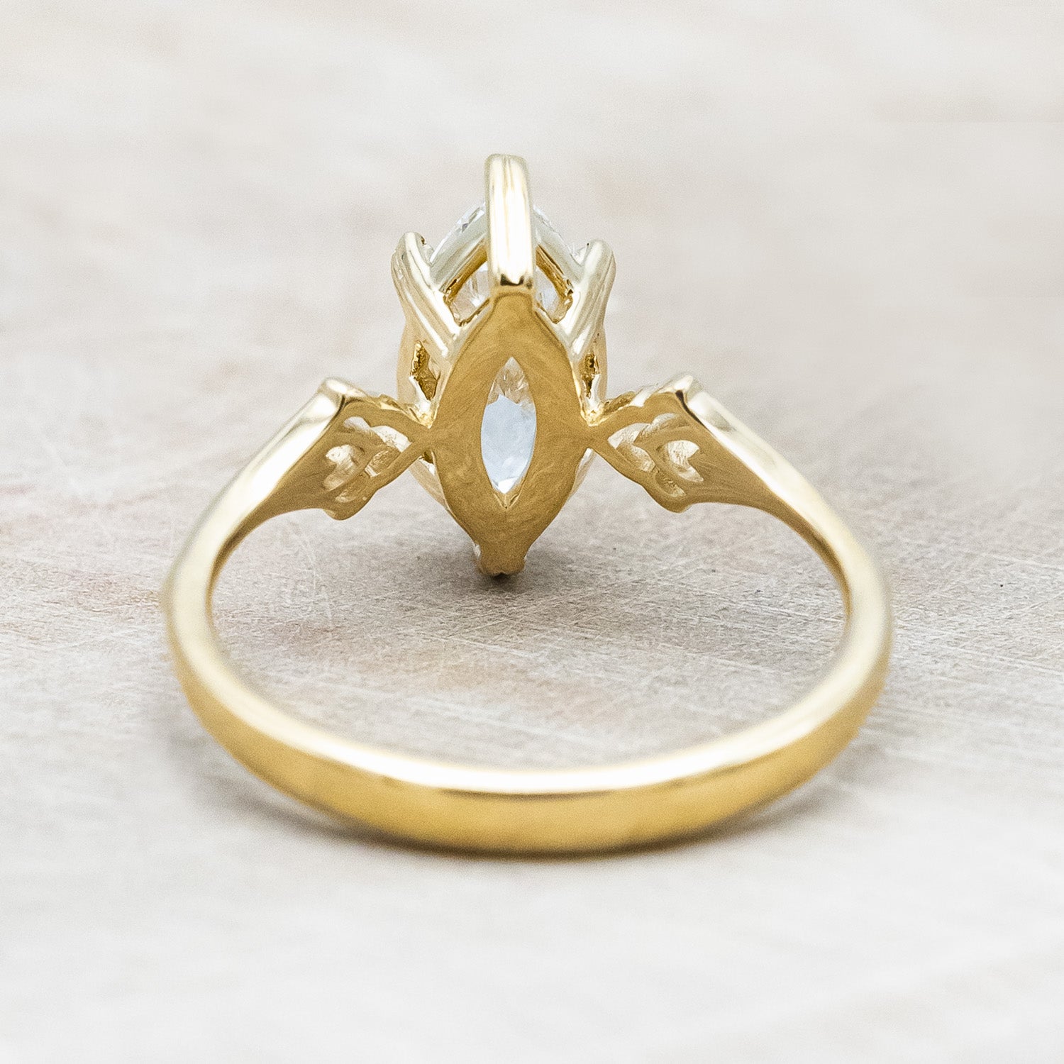 Back angle of "Morrigan" - ornate solitaire engagement ring with white marquise diamond