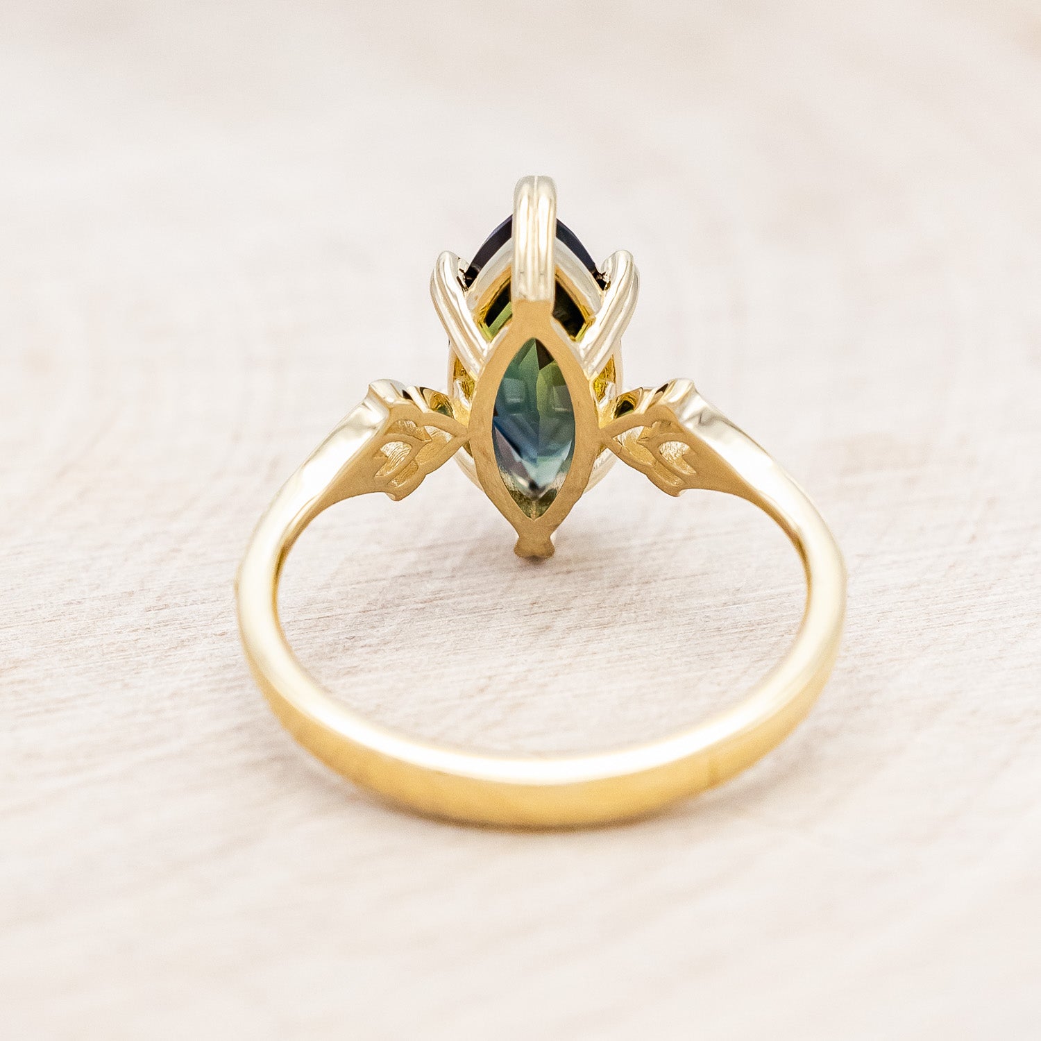 Back view of "Morrigan" - solitaire Australian sapphire women's engagement ring on an ornate 14K yellow gold band