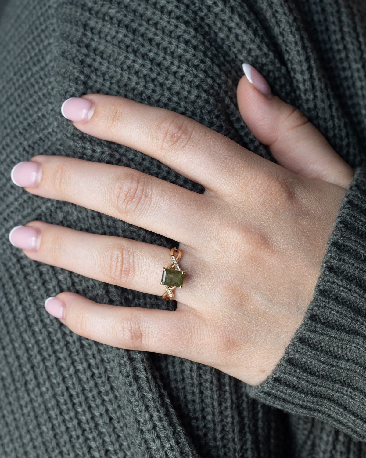 On hand of "Roslyn" - emerald cut moss agate women's engagement ring with diamond accents