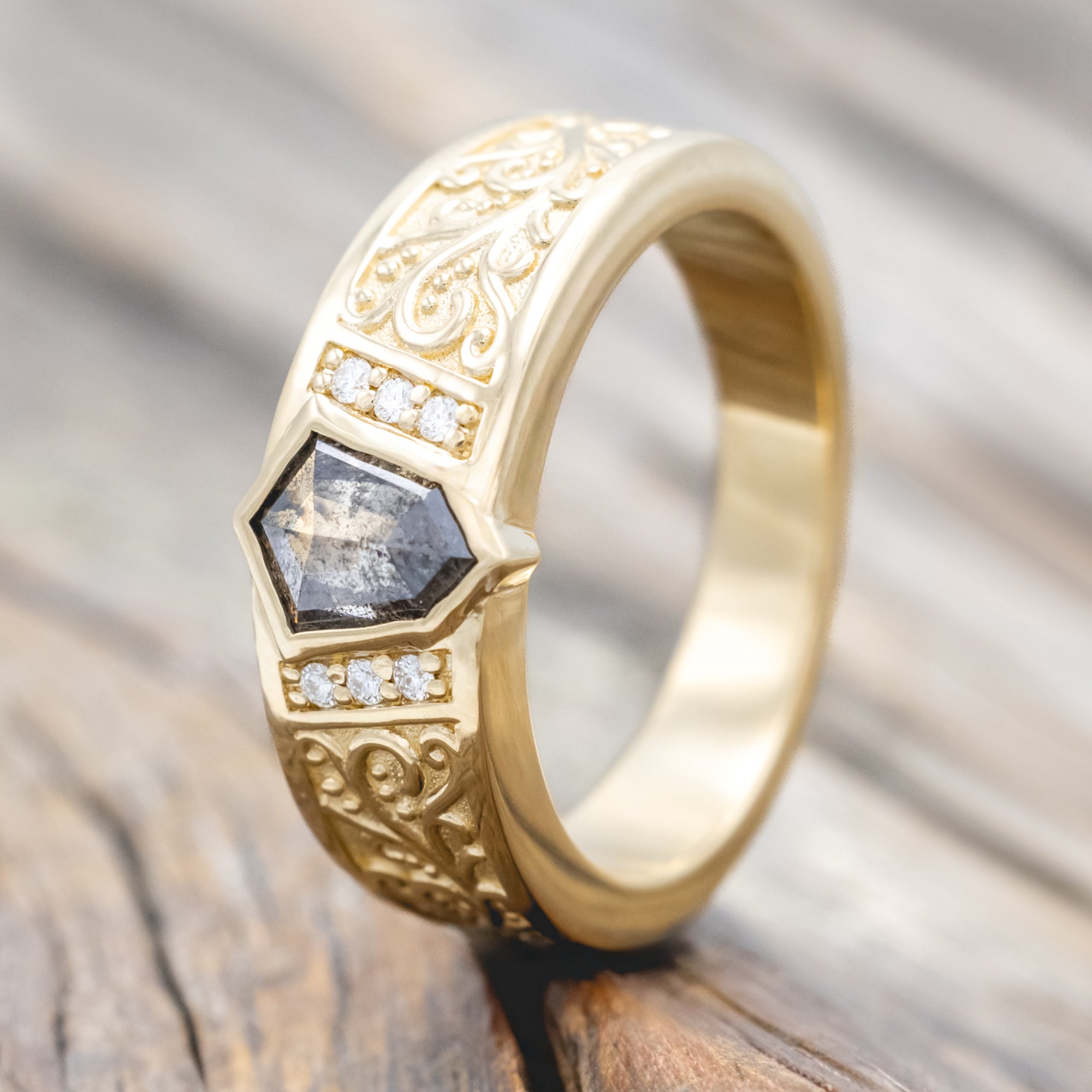 14K yellow gold ring with salt & pepper diamond and diamond accents on a wooden surface