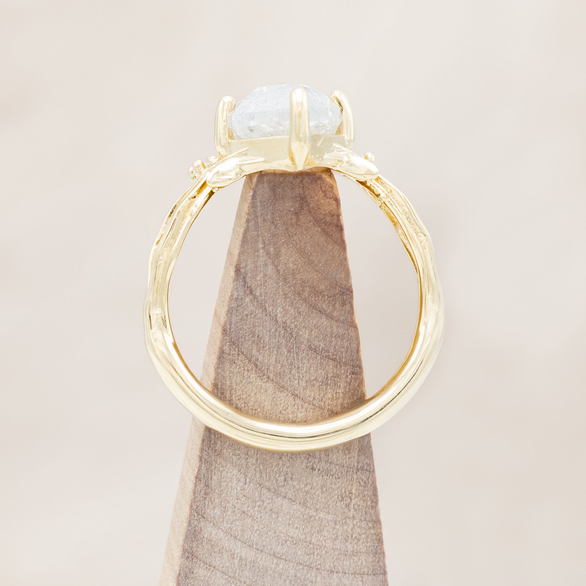 14K yellow gold ring with a salt & pepper diamond and diamond accents on a beige background