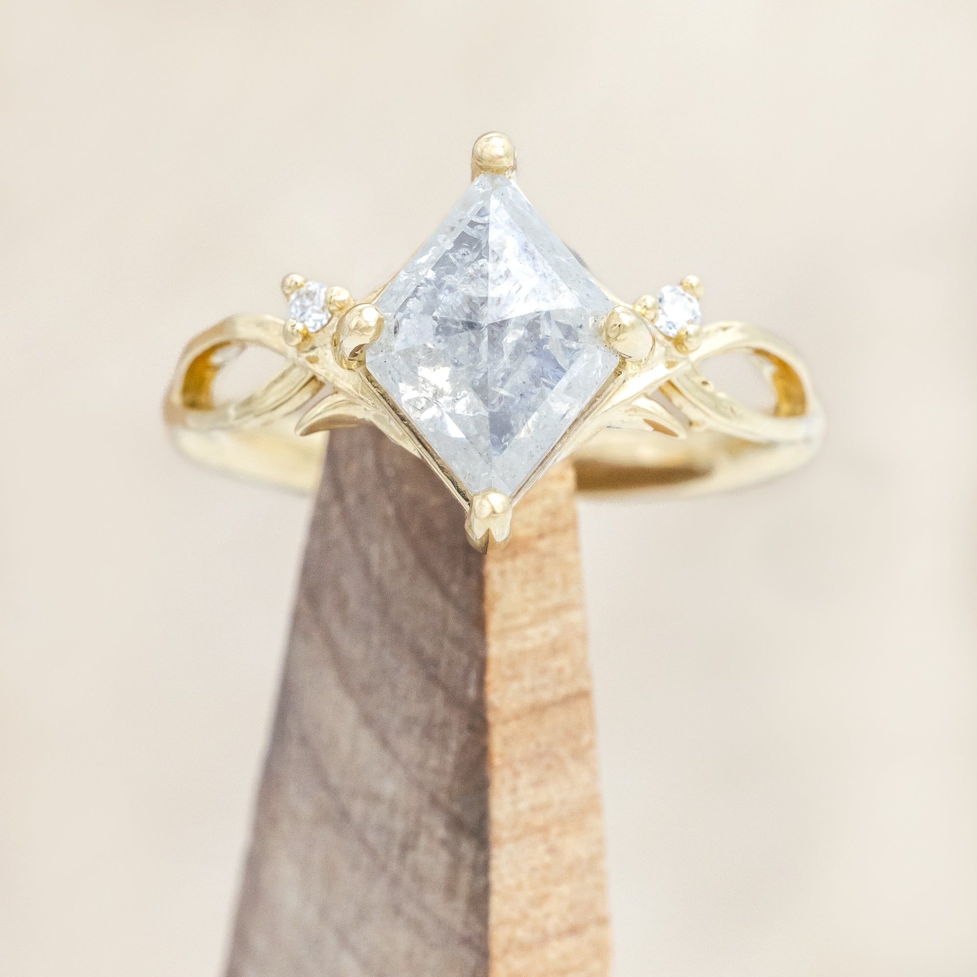 14K yellow gold ring with a salt & pepper diamond and diamond accents on a beige background