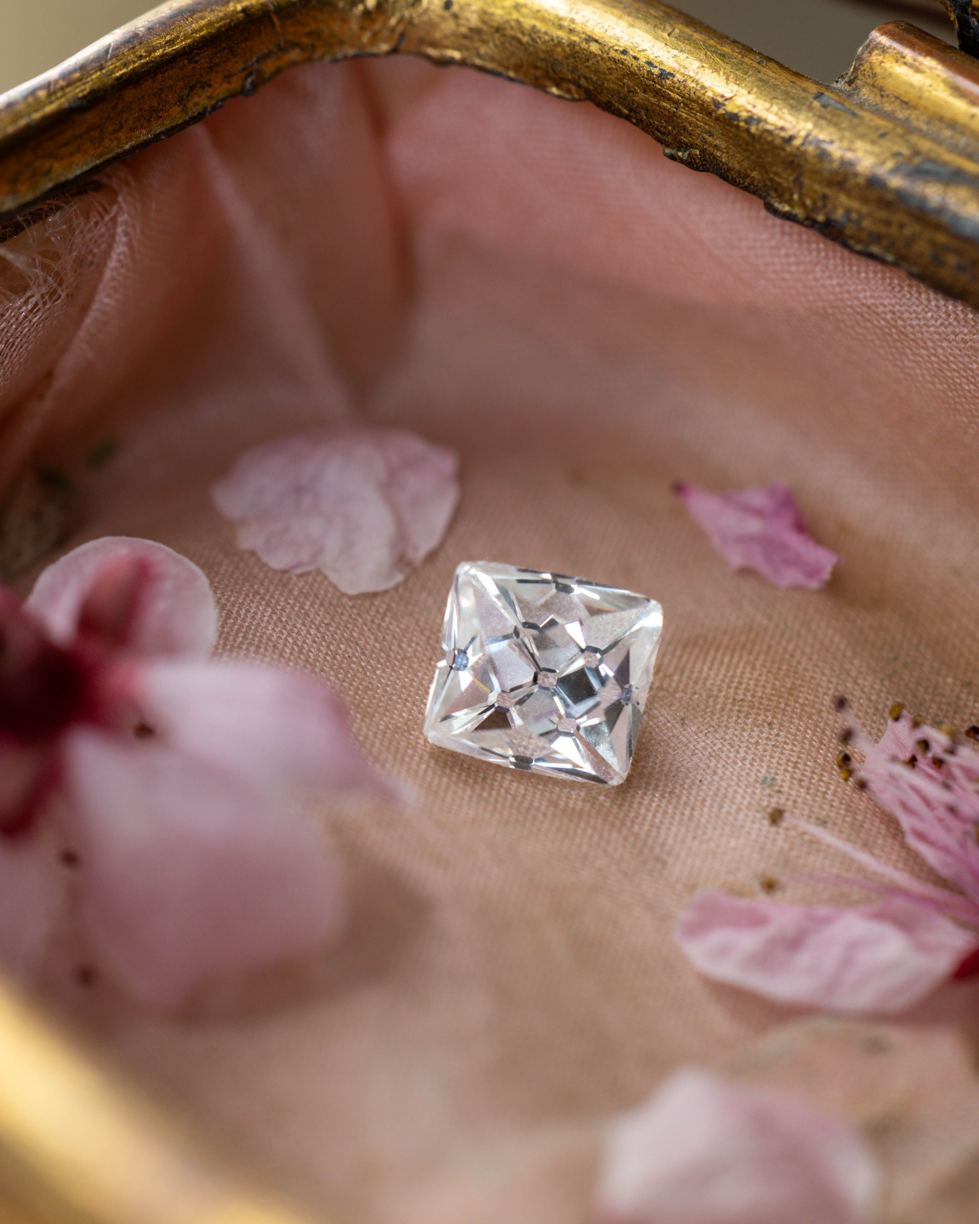 Diamond on a textured surface with pink flowers
