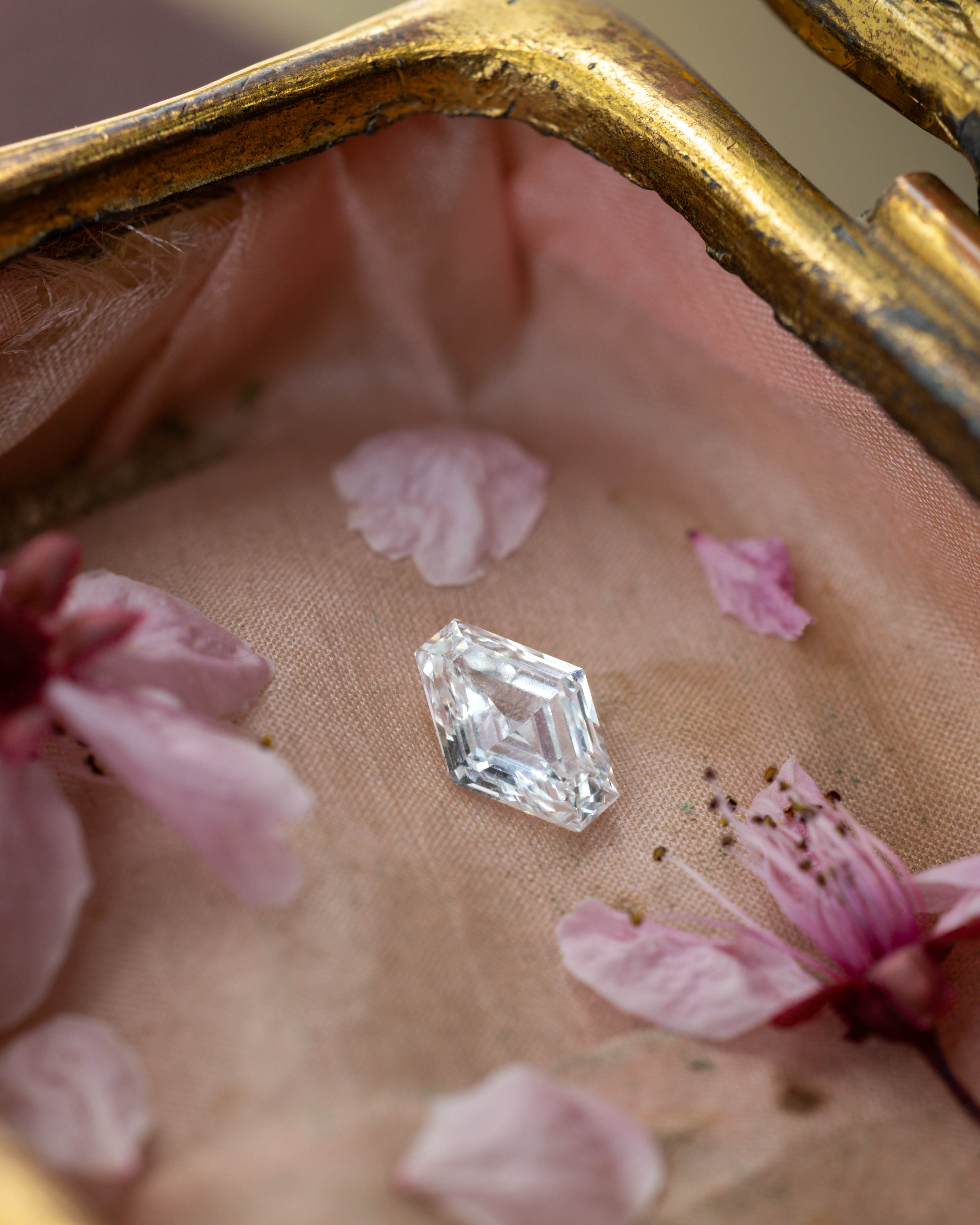 Lozenge cut diamond on a fabric surface with pink flowers