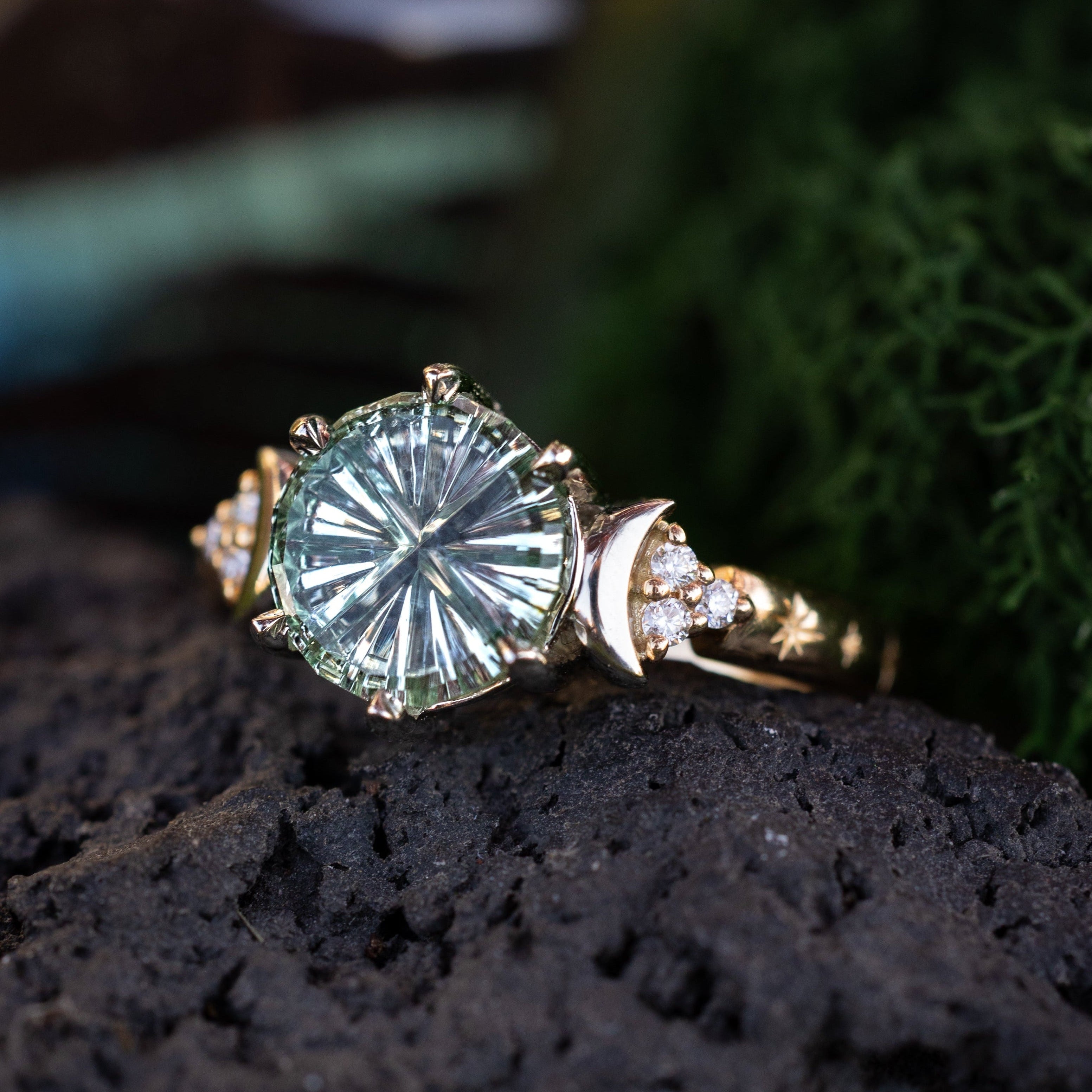 Gold ring with a large green sapphire on a dark surface with a natural background