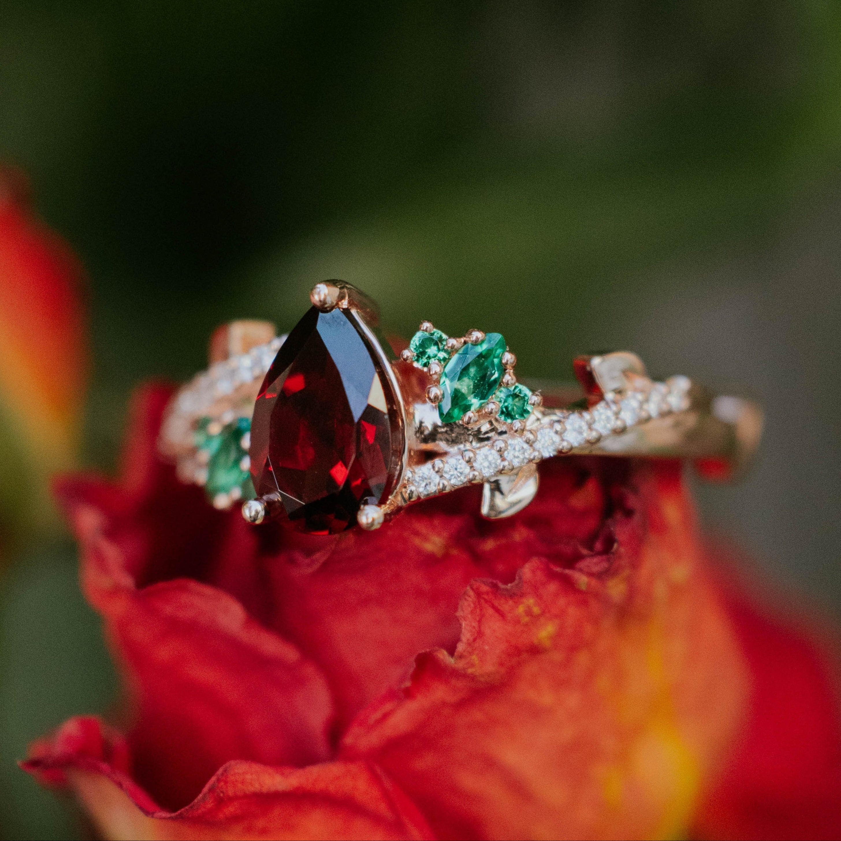 "KAMILA" - PEAR CUT MOZAMBIQUE GARNET ENGAGEMENT RING WITH LAB-GROWN EMERALD & DIAMOND ACCENTS-Staghead Designs