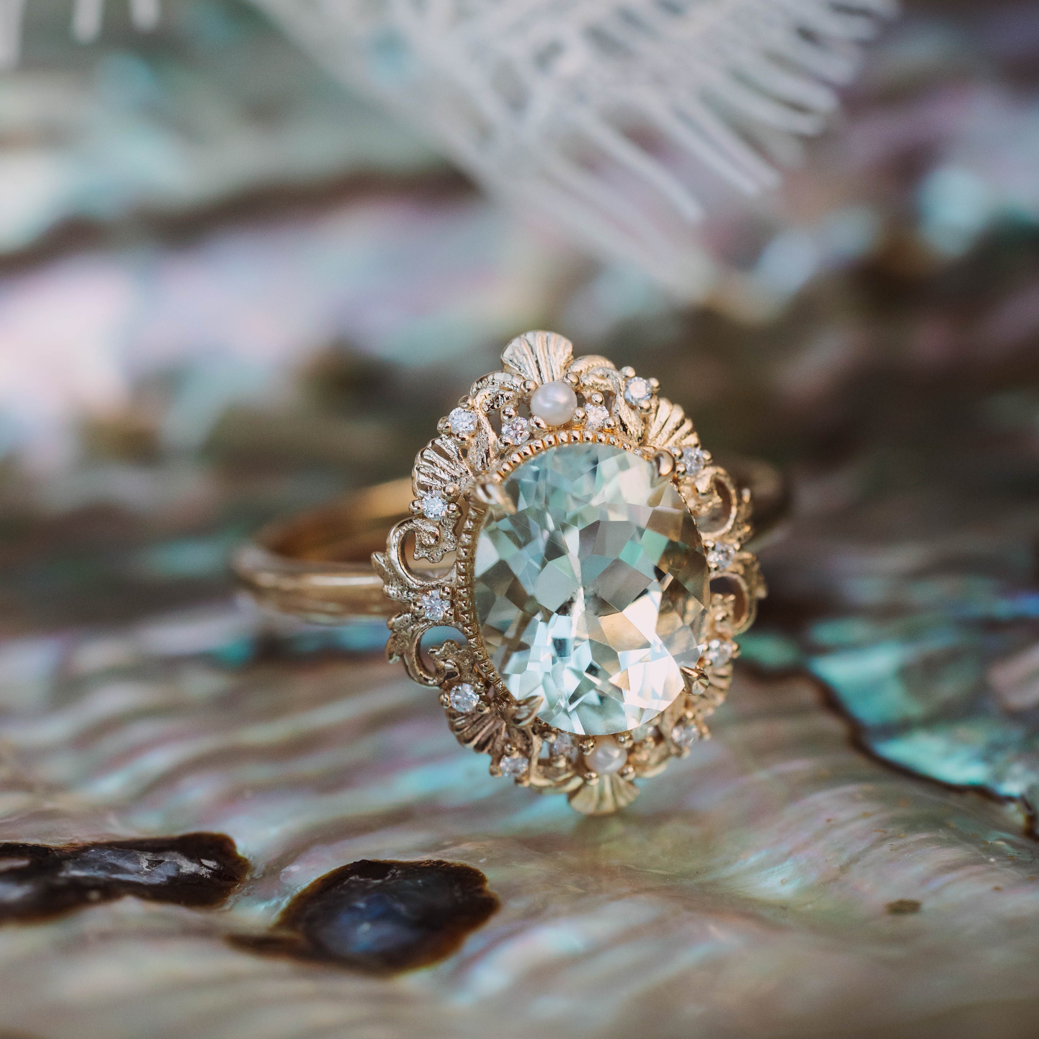Gold ring with a large green prasiolite on a shell background