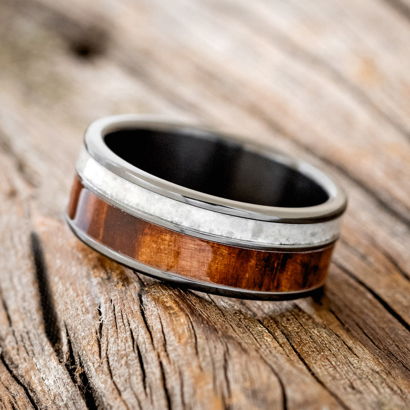 Shown here is "Raptor", a custom, handcrafted men's wedding ring featuring granite and redwood inlays, tilted left. Additional inlay options are available upon request.