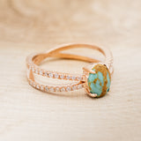 Shown here is "Anastasia", a split shank-style turquoise women's engagement ring with diamond accents, facing right.